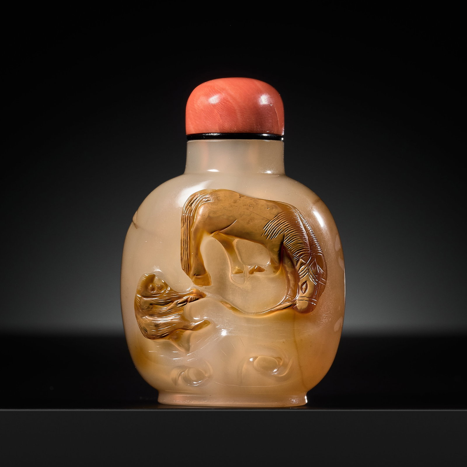 A CAMEO AGATE 'HORSE AND MONKEY' SNUFF BOTTLE, OFFICIAL SCHOOL, 1780-1850: A CAMEO AGATE 'HORSE AND MONKEY' SNUFF BOTTLE, OFFICIAL SCHOOL, 1780-1850 China. Well hollowed, the bottle of flattened, rounded square shape, supported on a short oval foot ring and rising to a cylin