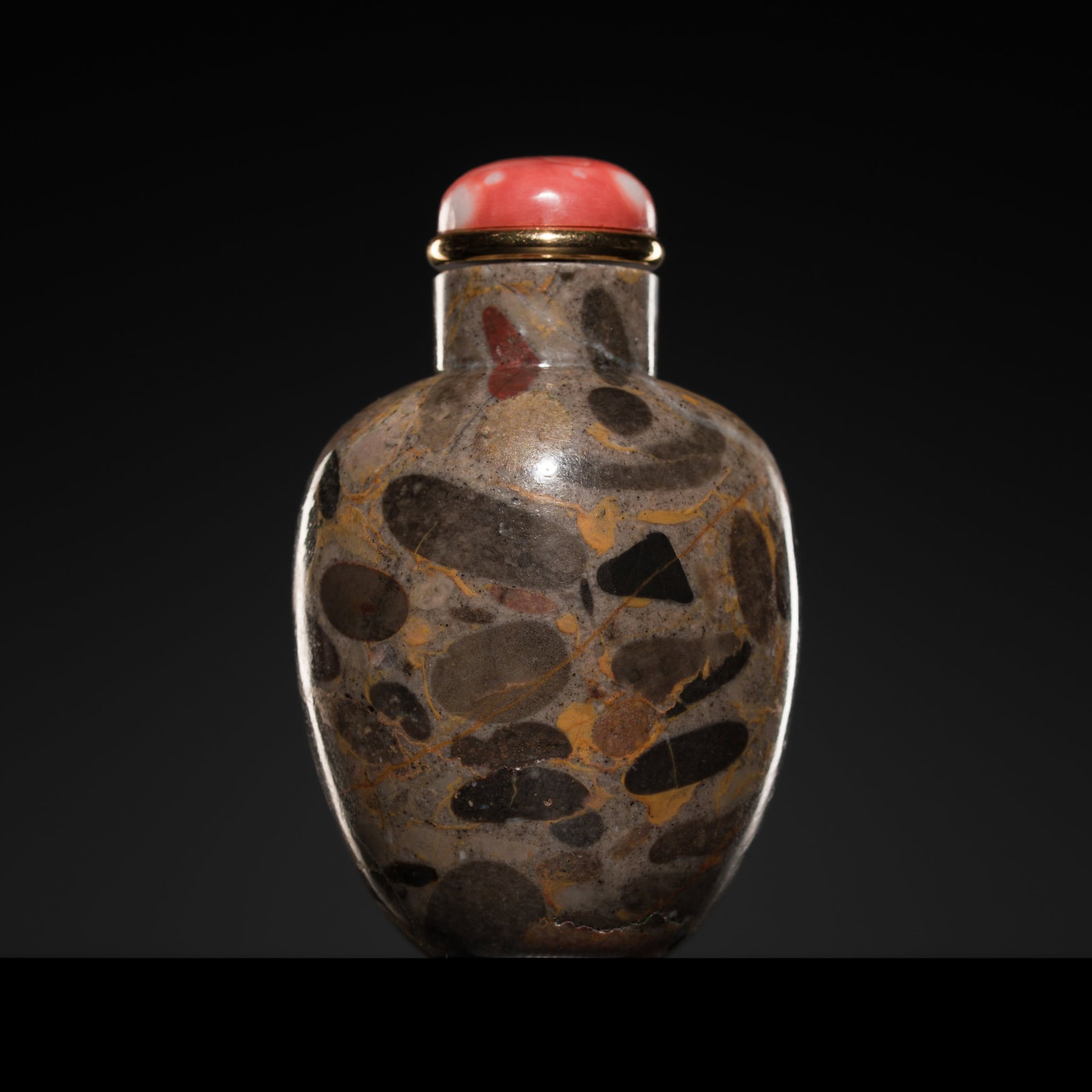 A RARE AND FINE 'PUDDINGSTONE' SNUFF BOTTLE, 1750-1850: A RARE AND FINE 'PUDDINGSTONE' SNUFF BOTTLE, 1750-1850 China. Very well hollowed, of tapering ovoid form, raised on a concave foot and rising to a cylindrical neck with a flat lip, the undecorated bod