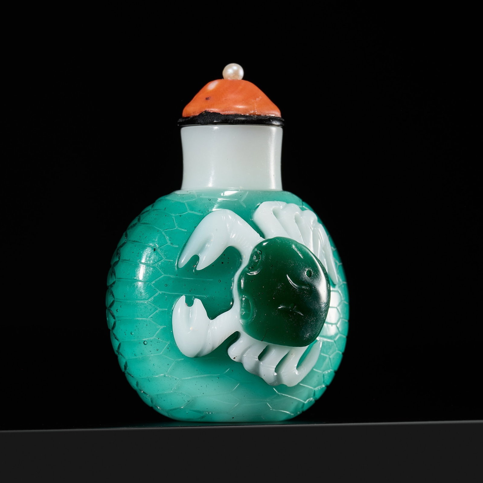 A RARE TRIPLE-OVERLAY 'CRABS' MILKY-WHITE GLASS SNUFF BOTTLE, 18TH-19TH CENTURY: A RARE TRIPLE-OVERLAY 'CRABS' MILKY-WHITE GLASS SNUFF BOTTLE, 18TH-19TH CENTURY China. Of compressed ovoid form, rising from an oval foot to a gently waisted neck with flat lip, the opaque white groun