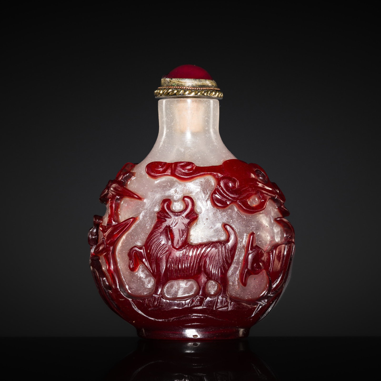 A RED-OVERLAY SNOWFLAKE GLASS 'SANYANG' SNUFF BOTTLE, 1750-1850: A RED-OVERLAY SNOWFLAKE GLASS 'SANYANG' SNUFF BOTTLE, 1750-1850 Published: Galerie Comes, Vienna, Feine Snuff Bottles aus China 17.-20.Jh., 1986, no. 43. China. The flattened globular body risin
