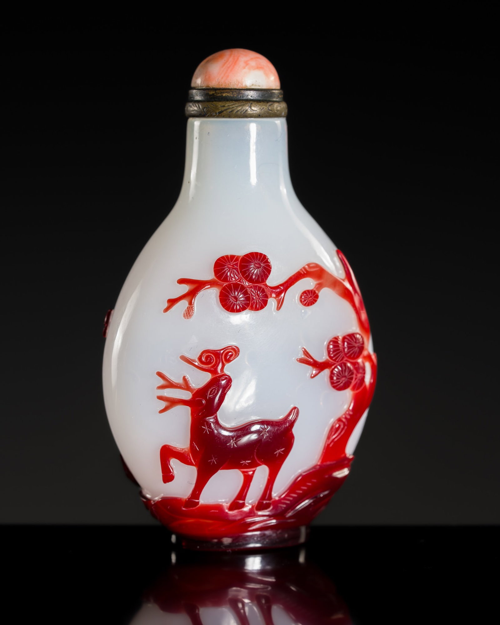 A RUBY-RED OVERLAY WHITE GLASS 'LONGEVITY' SNUFF BOTTLE, 1770-1850: A RUBY-RED OVERLAY WHITE GLASS 'LONGEVITY' SNUFF BOTTLE, 1770-1850 China. The flattened ovoid body supported on an oval foot and rising to a cylindrical neck, finely carved through the ruby-red layer 