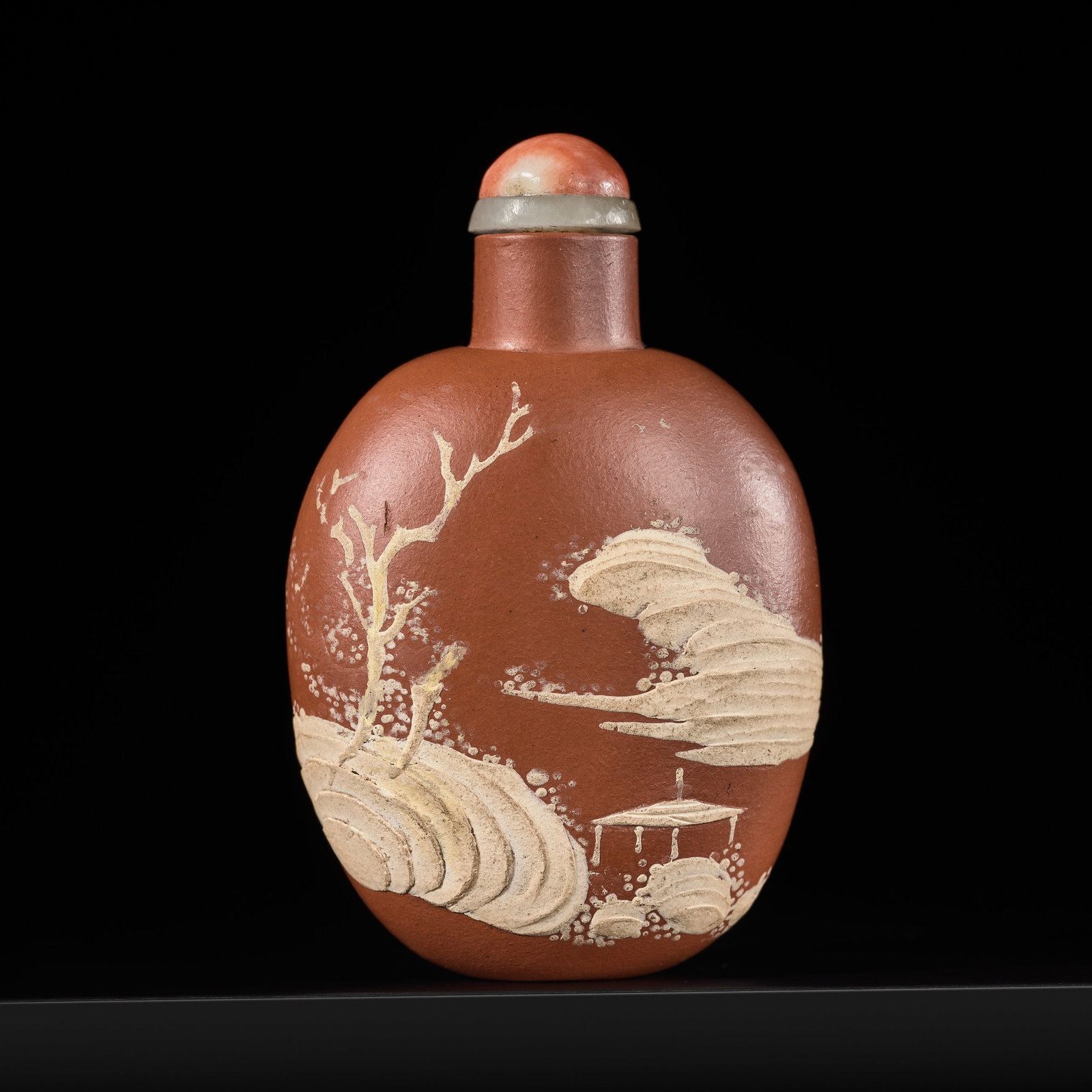 A SLIP DECORATED BROWN STONEWARE SNUFF BOTTLE, YIXING, 19TH CENTURY: A SLIP DECORATED BROWN STONEWARE SNUFF BOTTLE, YIXING, 19TH CENTURY China. Of ovoid form, rising from a concave foot to a thin tubular neck with concave lip, decorated to each side with a design in ap