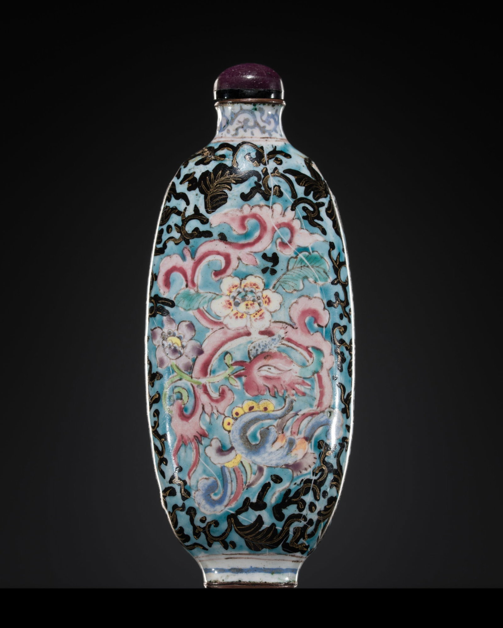 AN ENAMEL ON COPPER 'PHOENIX' SNUFF BOTTLE, POSSIBLY IMPERIAL, PALACE WORKSHOPS, GUANGZHOU,: AN ENAMEL ON COPPER 'PHOENIX' SNUFF BOTTLE, POSSIBLY IMPERIAL, PALACE WORKSHOPS, GUANGZHOU, 1720-1750 China. The elongated ovoid bottle with a spreading neck, thin lip, raised oval foot, painted in en