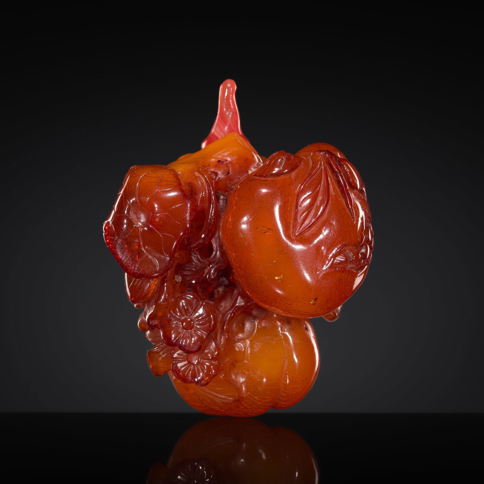 A CARVED BALTIC AMBER 'AUSPICIOUS FRUITS' SNUFF BOTTLE, POSSIBLY IMPERIAL, 18TH CENTURY: † A CARVED BALTIC AMBER 'AUSPICIOUS FRUITS' SNUFF BOTTLE, POSSIBLY IMPERIAL, 18TH CENTURY Expert's note: There seems to be a strong likelihood that the workshops that produced amber bottles of t