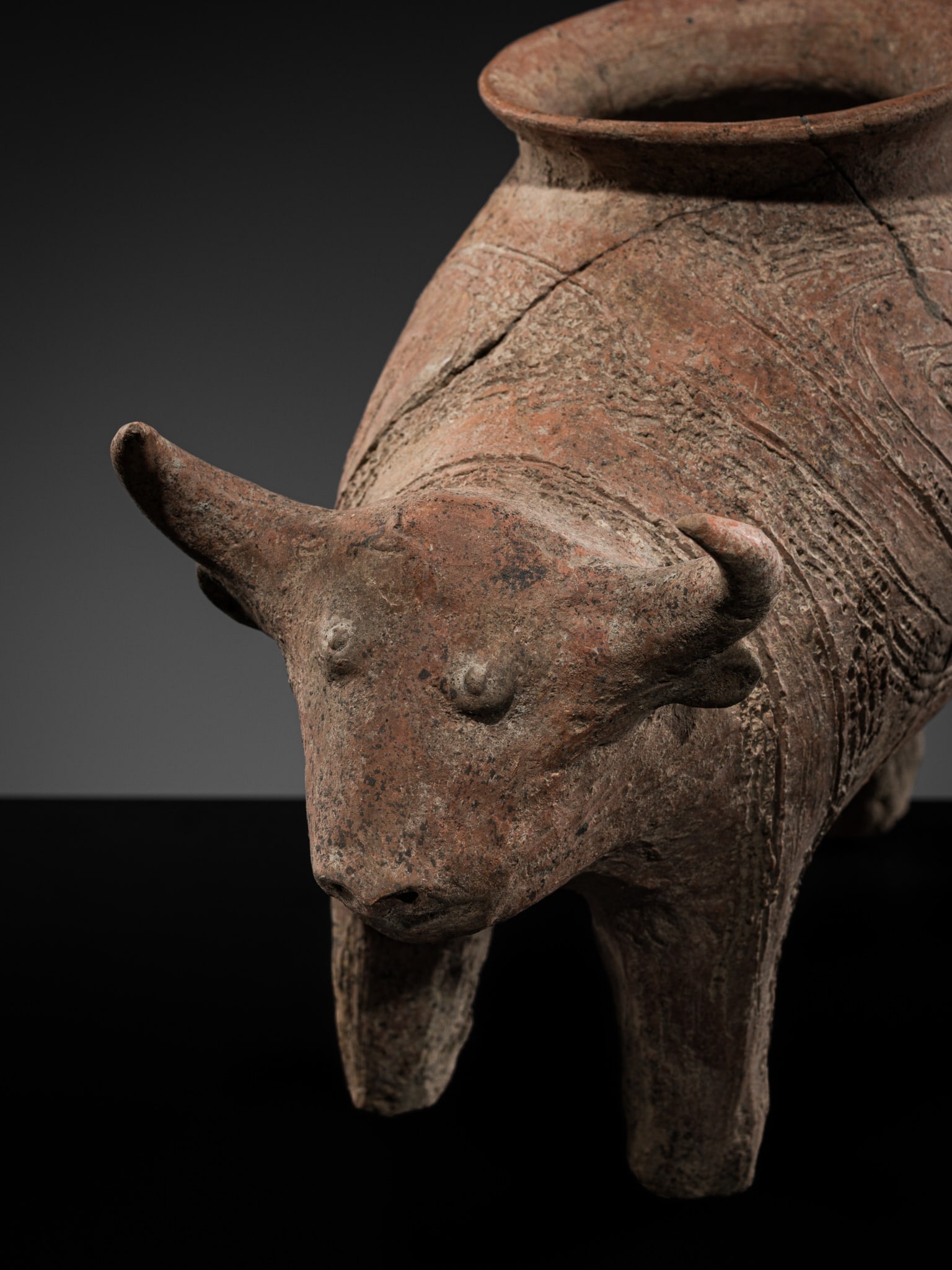 A RARE TERRACOTTA CEREMONIAL VESSEL IN THE FORM OF A WATER BUFFALO, BAN CHIANG, 1000-300 BC: A RARE TERRACOTTA CEREMONIAL VESSEL IN THE FORM OF A WATER BUFFALO, BAN CHIANG, 1000-300 BC This lot is from a single owner collection and is therefore offered without reserve Thailand, Udon Thani Pro