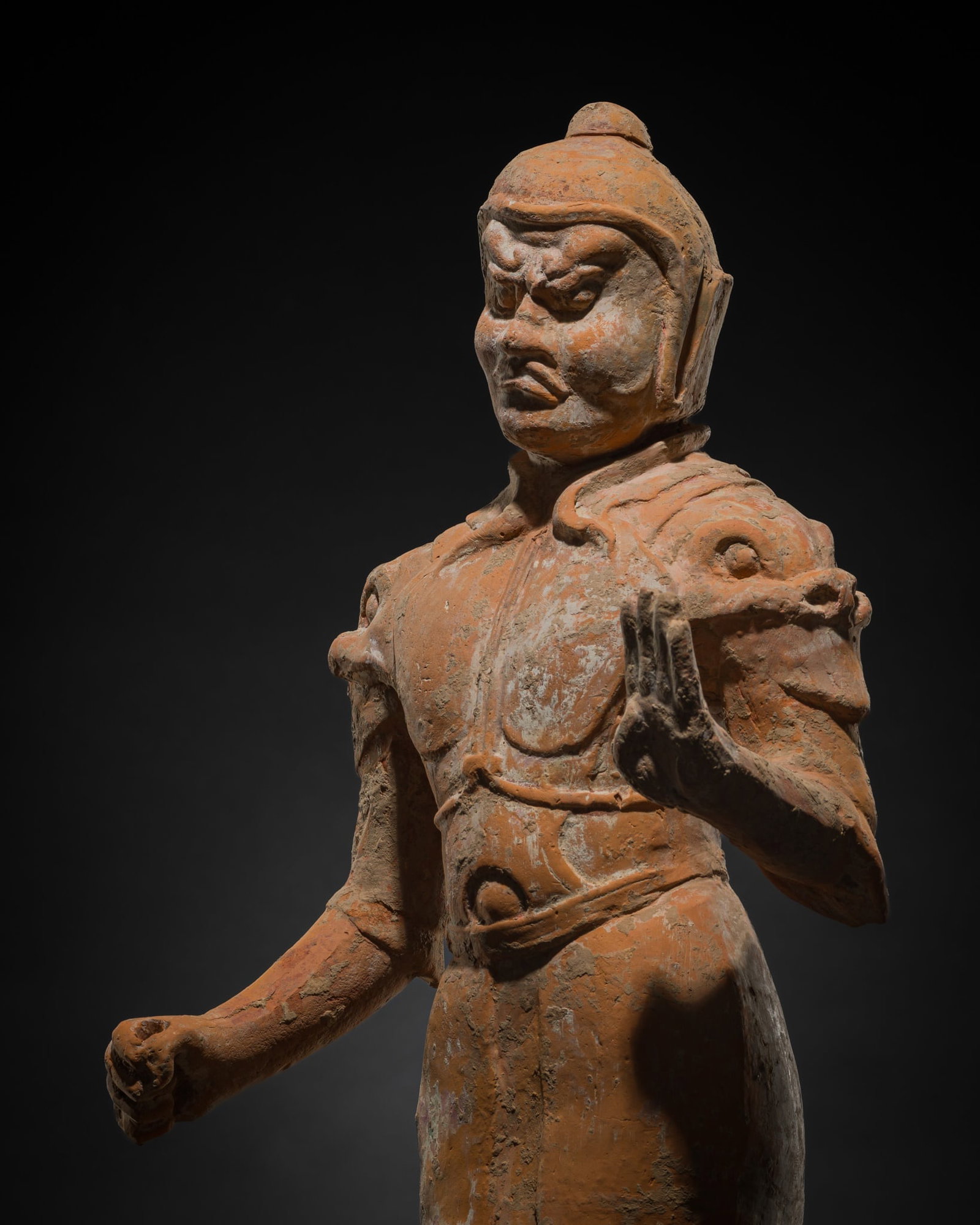 A LARGE PAINTED RED POTTERY FIGURE OF A WARRIOR, TANG DYNASTY: A LARGE PAINTED RED POTTERY FIGURE OF A WARRIOR, TANG DYNASTY This lot is from a single owner collection and is therefore offered without reserve China, 618-907. Well-proportioned, standing in contrap