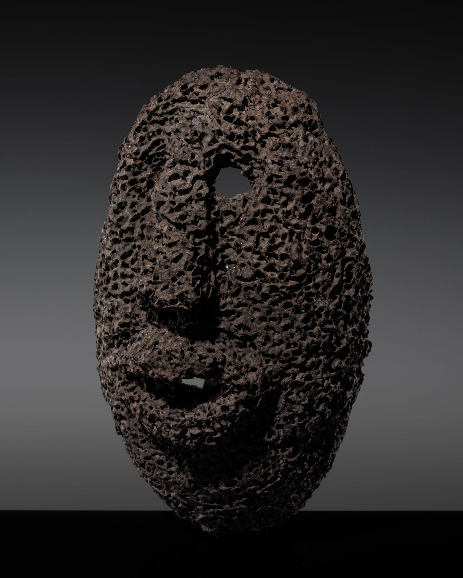 AN ANCESTOR MASK BY MODEST: AN ANCESTOR MASK BY MODEST This lot is from a single owner collection and is therefore offered without reserve Togo, late 20th-21st century. Formed from an arboreal ant nest, its naturally labyrinthin