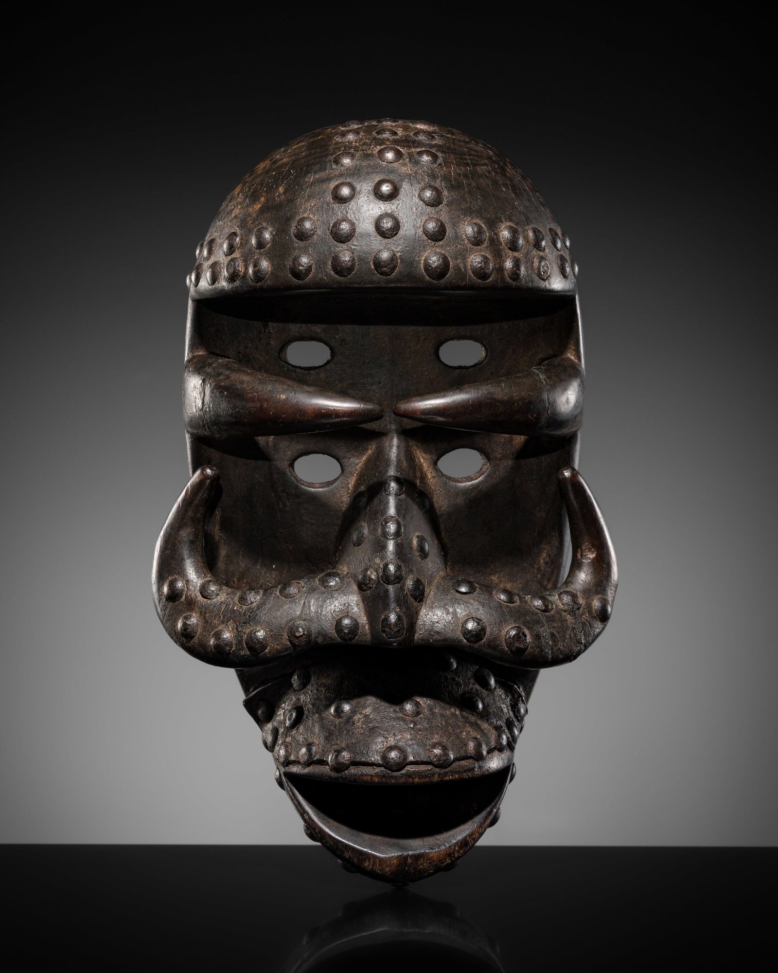 A BETE WOOD AND IRON MASK, LATE 19TH-20TH CENTURY: A BETE WOOD AND IRON MASK, LATE 19TH-20TH CENTURY This lot is from a single owner collection and is therefore offered without reserve Expert's note: Historically identified as emanating from the Bete 