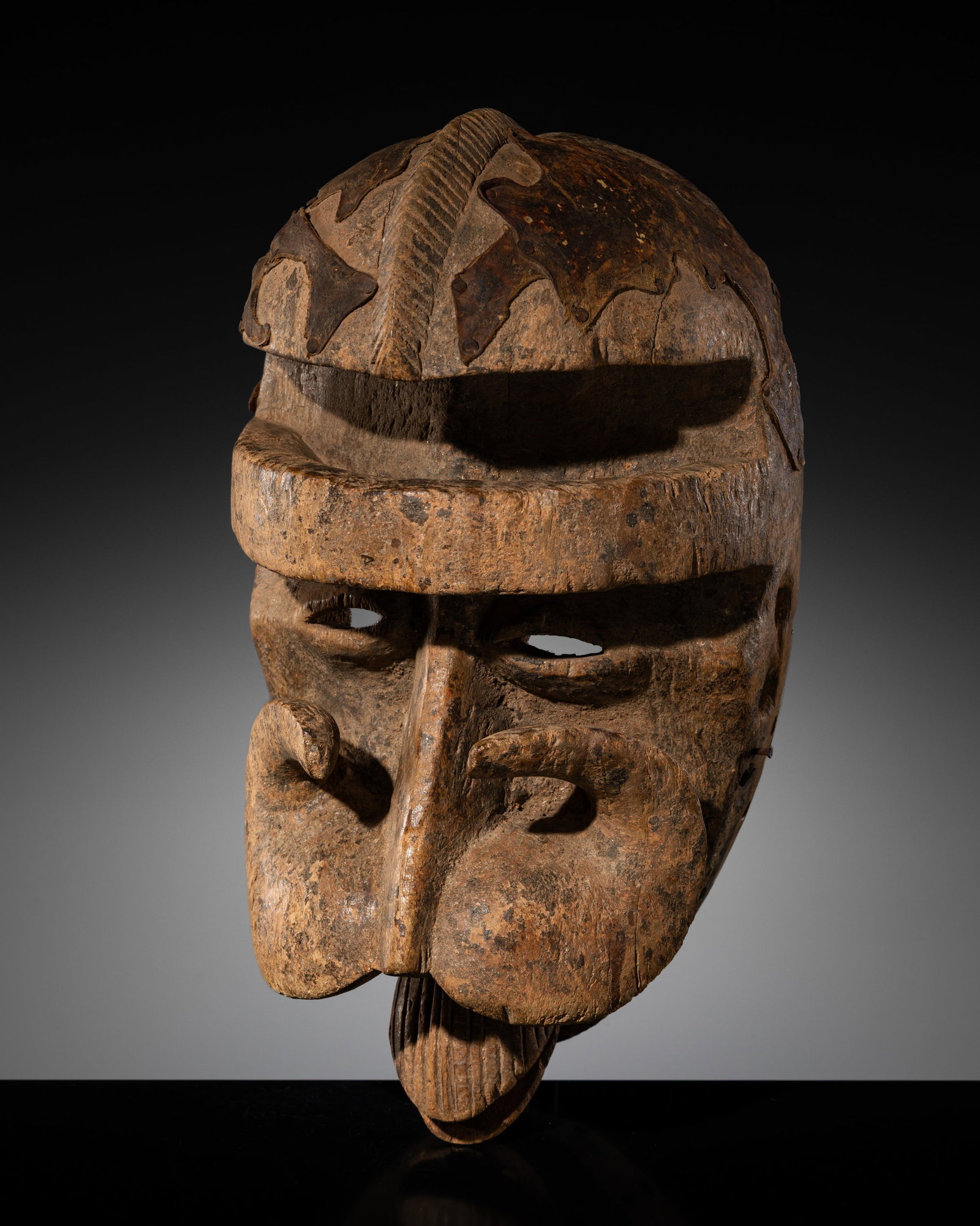A BETE WOOD MASK, 20TH CENTURY: A BETE WOOD MASK, 20TH CENTURY This lot is from a single owner collection and is therefore offered without reserve Côte d'Ivoire. Carved with an intense glare, the dimensional aspects of the comp