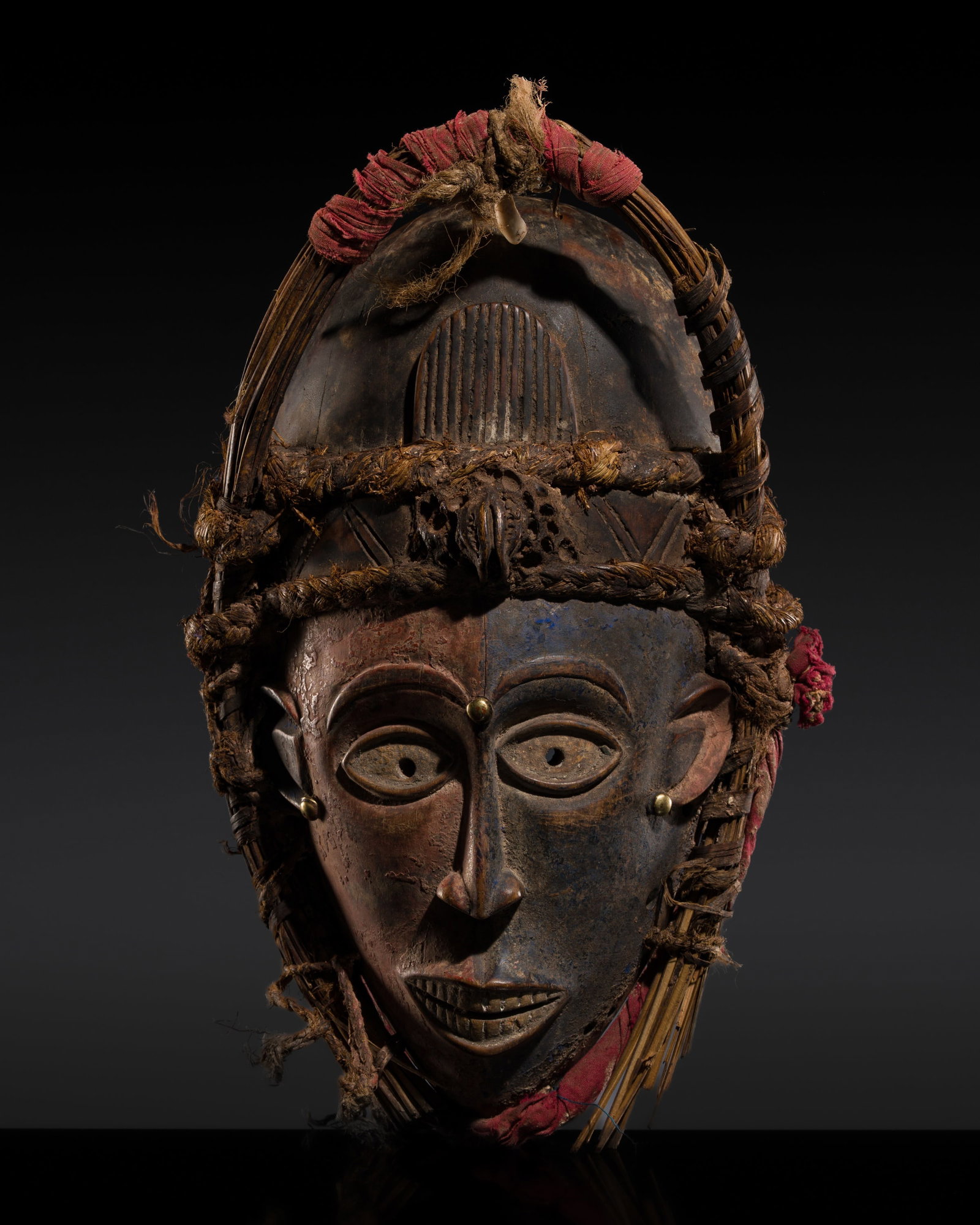 A CHOKWE PAINTED WOOD MASK OF A YOUNG WOMAN, MWANA PWO, 20TH CENTURY (1 of 12)