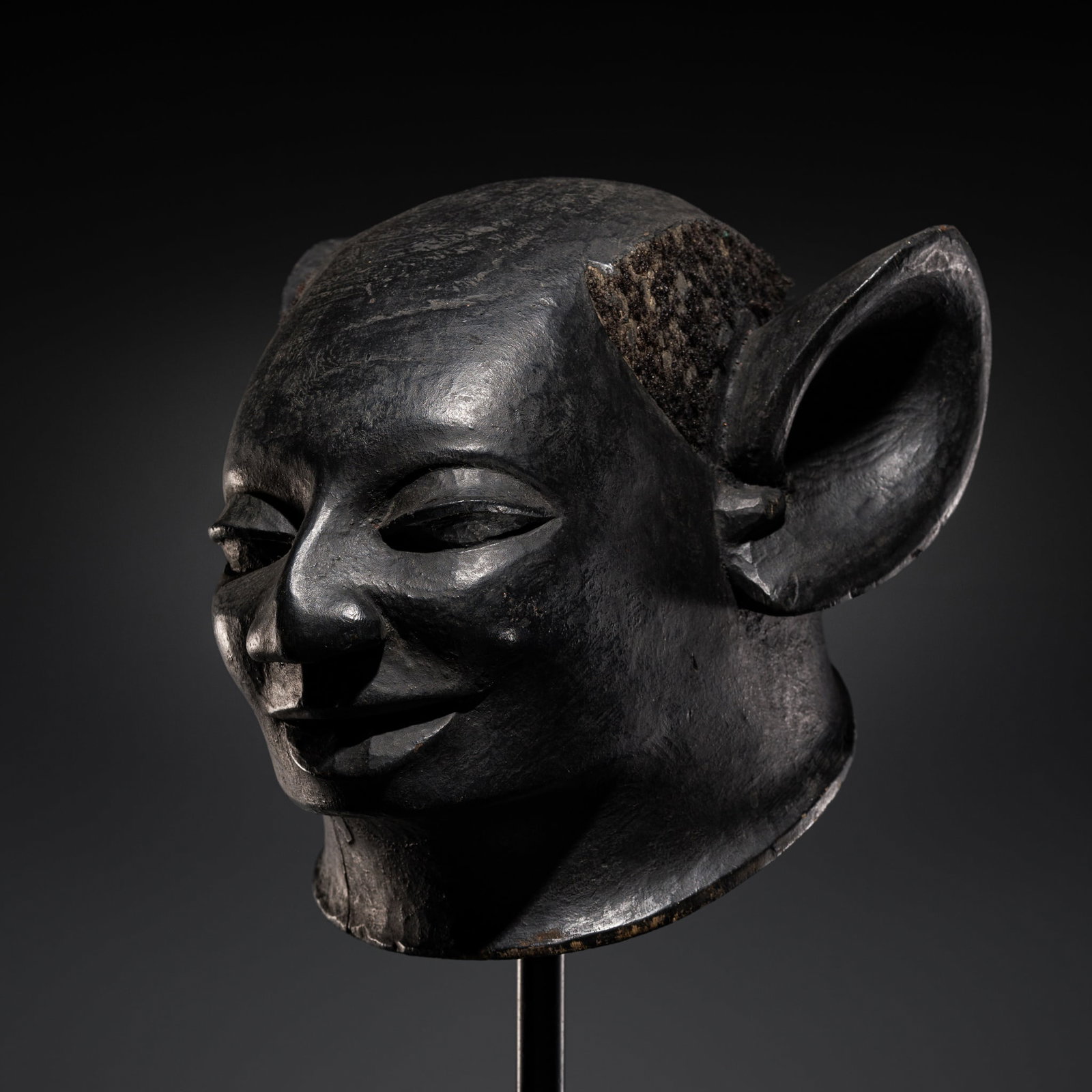 A MAKONDE LACQUERED WOOD HELMET MASK, LIPIKO, 19TH-20TH CENTURY: A MAKONDE LACQUERED WOOD HELMET MASK, LIPIKO, 19TH-20TH CENTURY This lot is from a single owner collection and is therefore offered without reserve Mozambique or Tanzania. Finely carved with a rounded