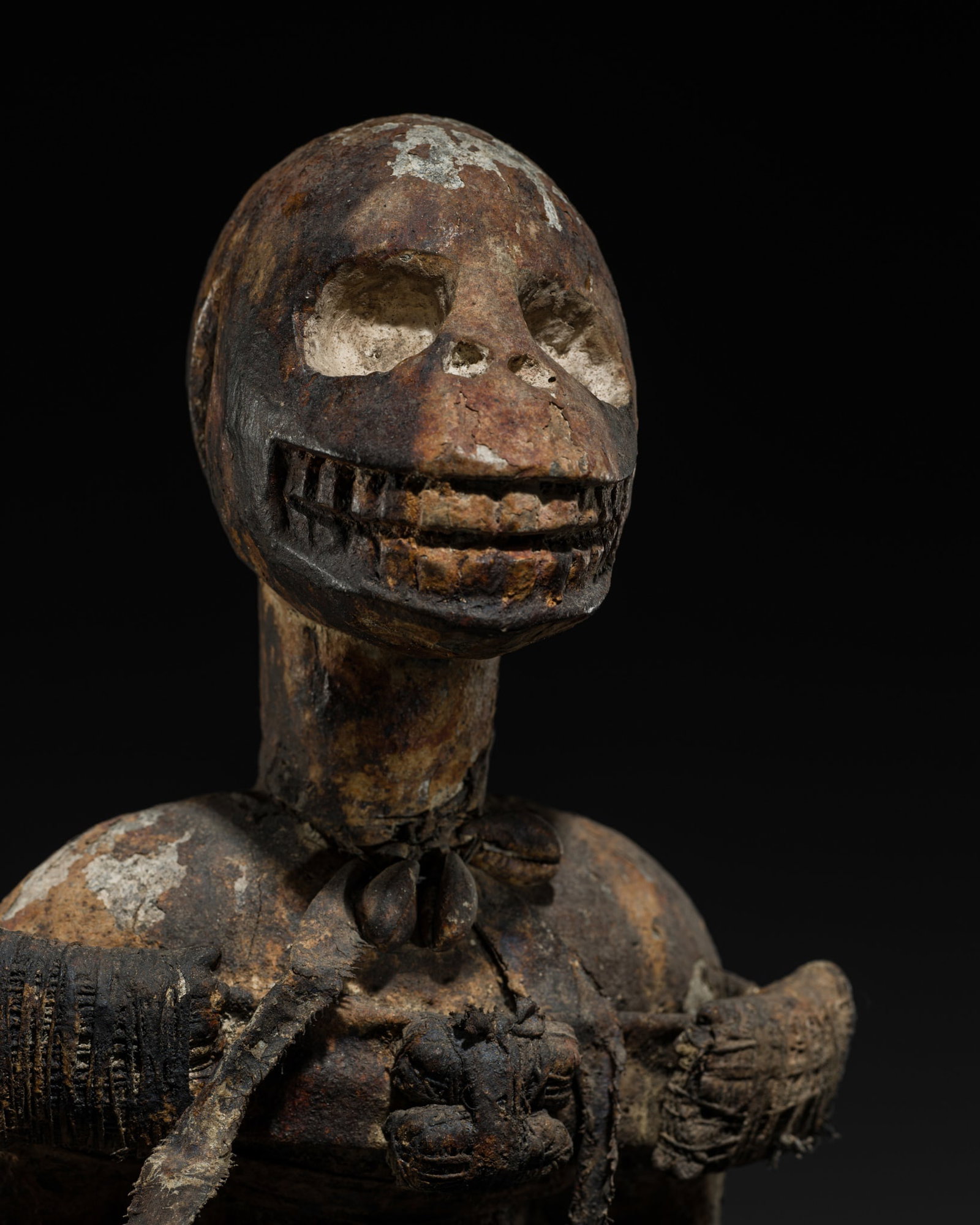 A BAULE WOOD FIGURE OF A MONKEY, 20TH CENTURY: A BAULE WOOD FIGURE OF A MONKEY, 20TH CENTURY This lot is from a single owner collection and is therefore offered without reserve Côte d'Ivoire. The figure is carved seated on a chair, with a lon