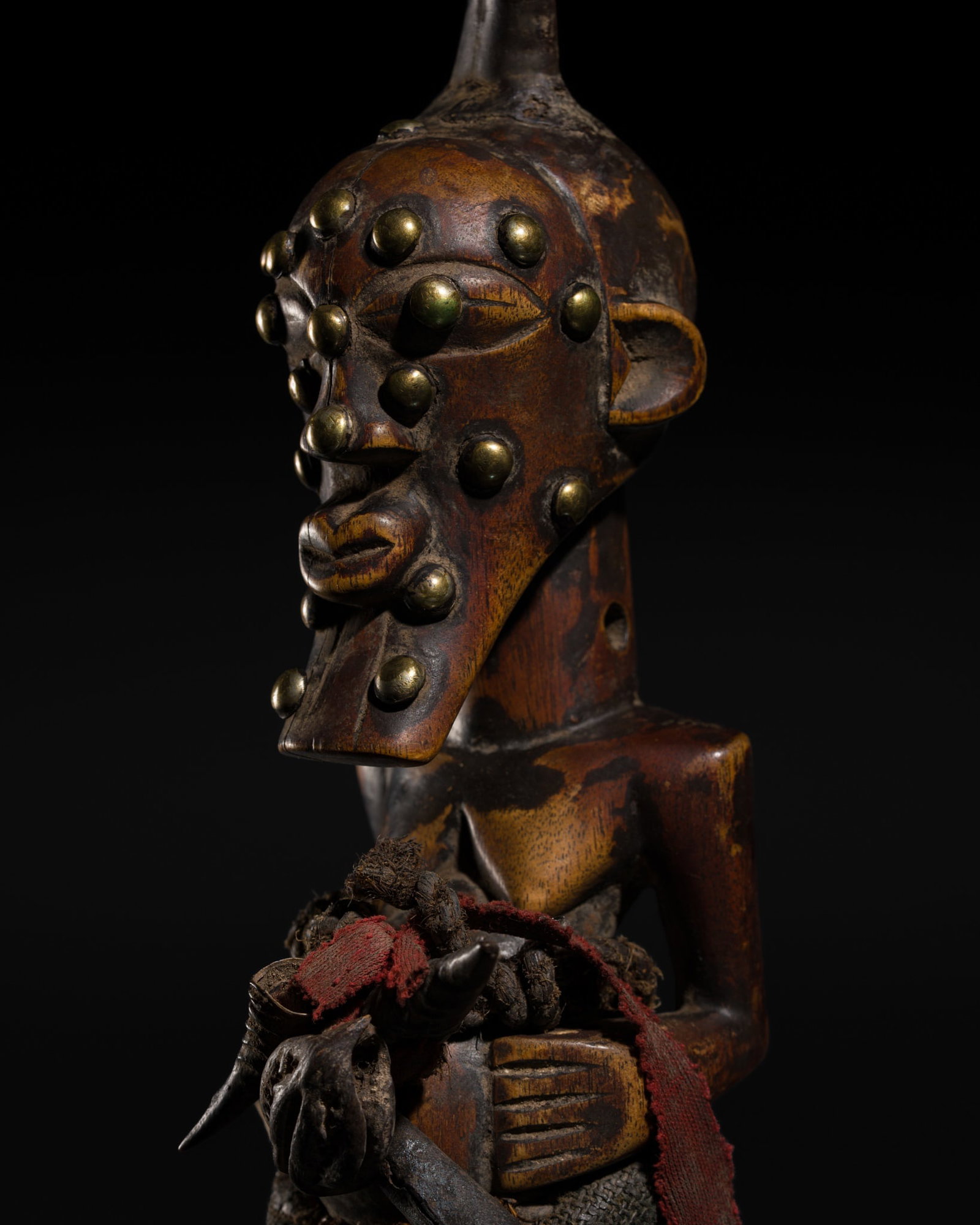 A SONGYE WOOD POWER FIGURE, NKISI, 19TH-20TH CENTURY: A SONGYE WOOD POWER FIGURE, NKISI, 19TH-20TH CENTURY This lot is from a single owner collection and is therefore offered without reserve Democratic Republic of the Congo. The seated figure boldly carv