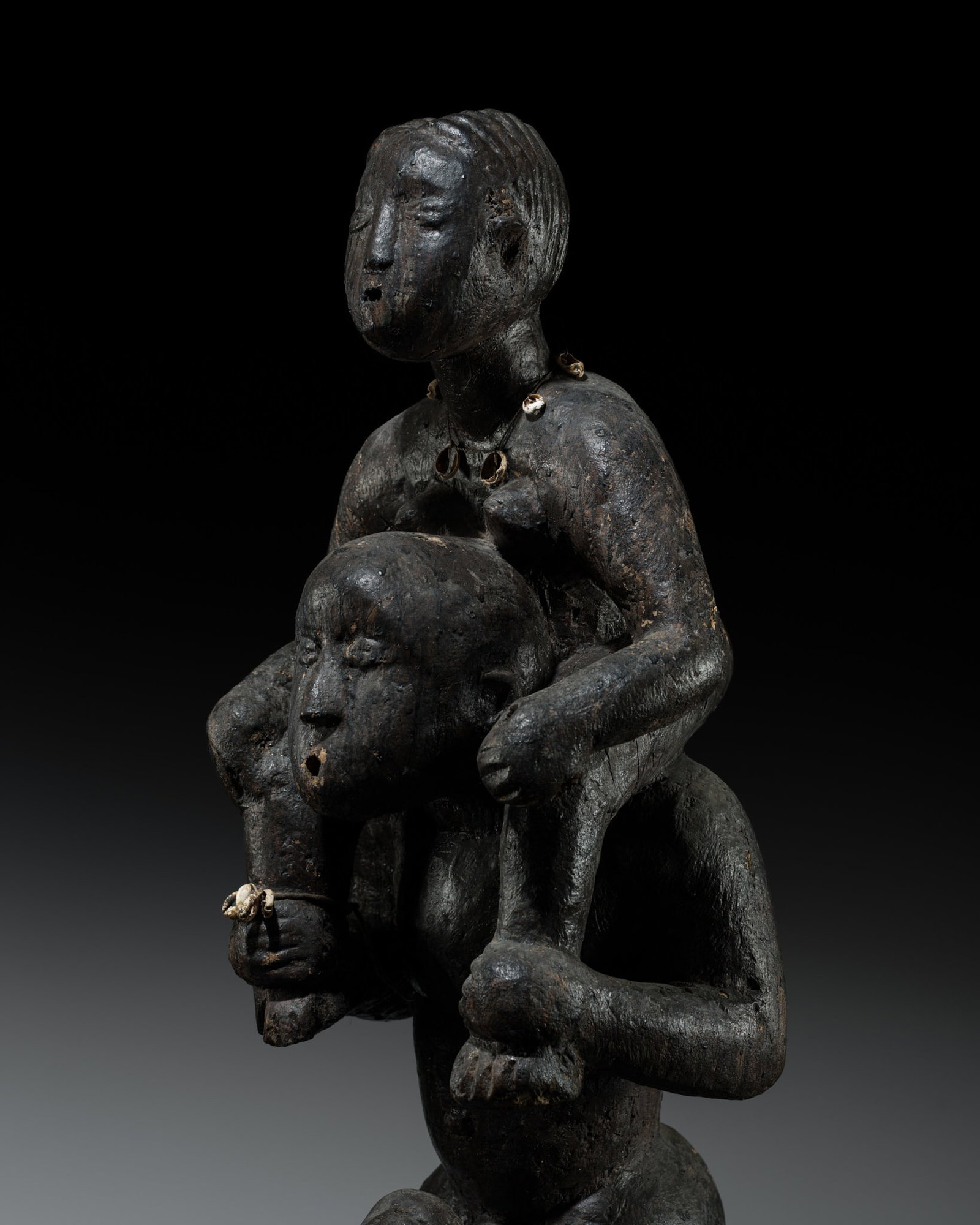 A LARGE WOOD VOODOO GROUP, TOGO, 20TH CENTURY: A LARGE WOOD VOODOO GROUP, TOGO, 20TH CENTURY This lot is from a single owner collection and is therefore offered without reserve Heavily and boldly carved as three figures on a circular base, the fat