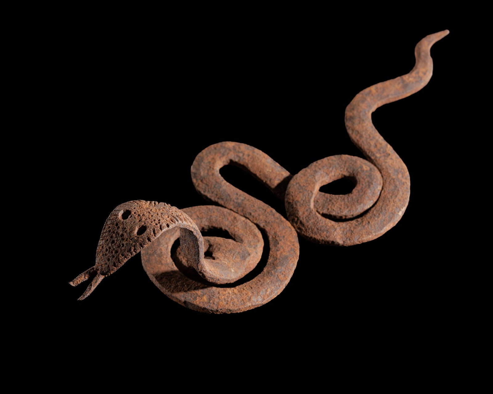 AN IRON VOODOO FIGURE OF A SNAKE, TOGO, 19TH-20TH CENTURY: AN IRON VOODOO FIGURE OF A SNAKE, TOGO, 19TH-20TH CENTURY This lot is from a single owner collection and is therefore offered without reserve Forged from iron, the serpent rendered in a highly stylize