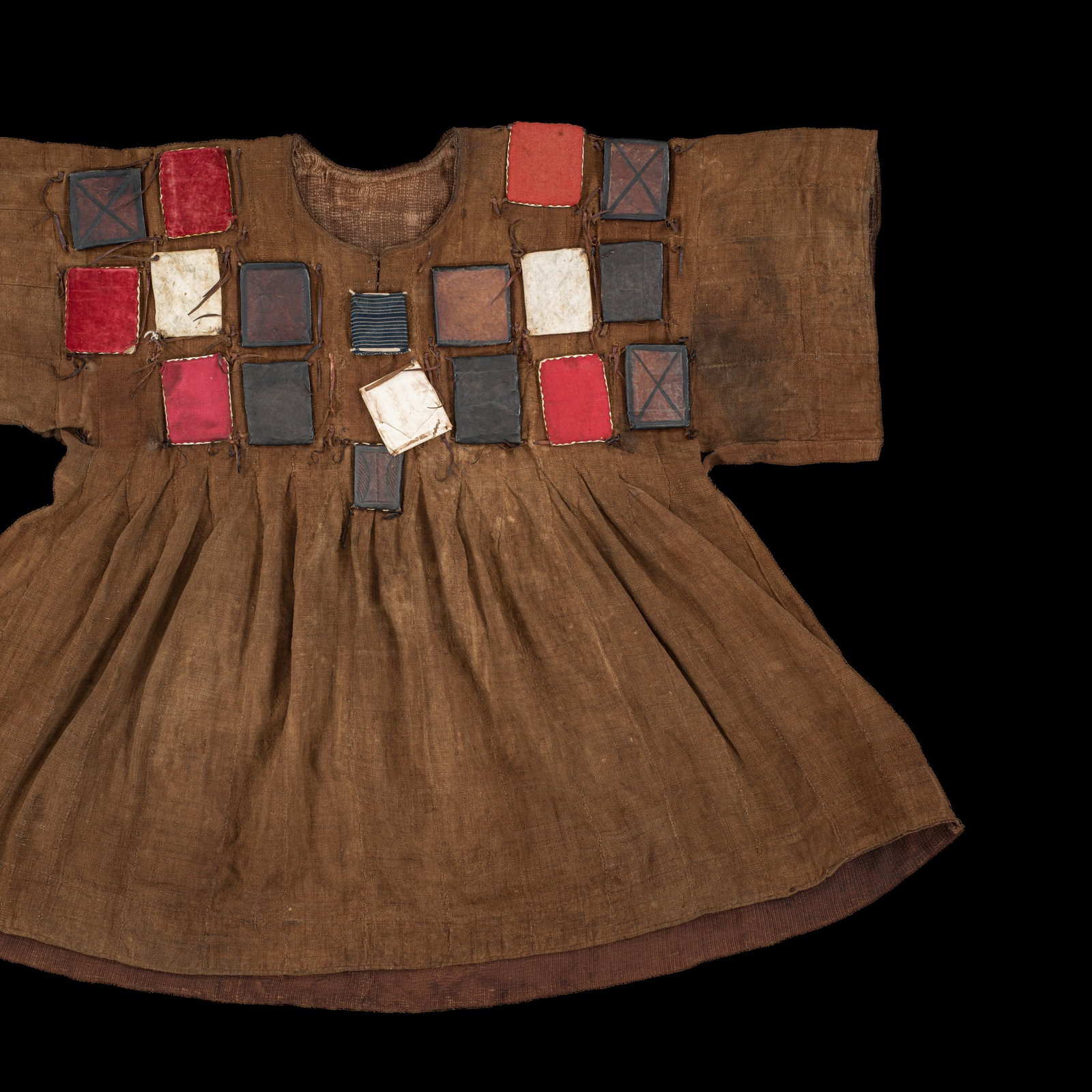 AN ASHANTI WAR SHIRT, BATAKARI, 20TH CENTURY: AN ASHANTI WAR SHIRT, BATAKARI, 20TH CENTURY This lot is from a single owner collection and is therefore offered without reserve Ghana. Of typical tunic form, cut from brown cotton, the front and back