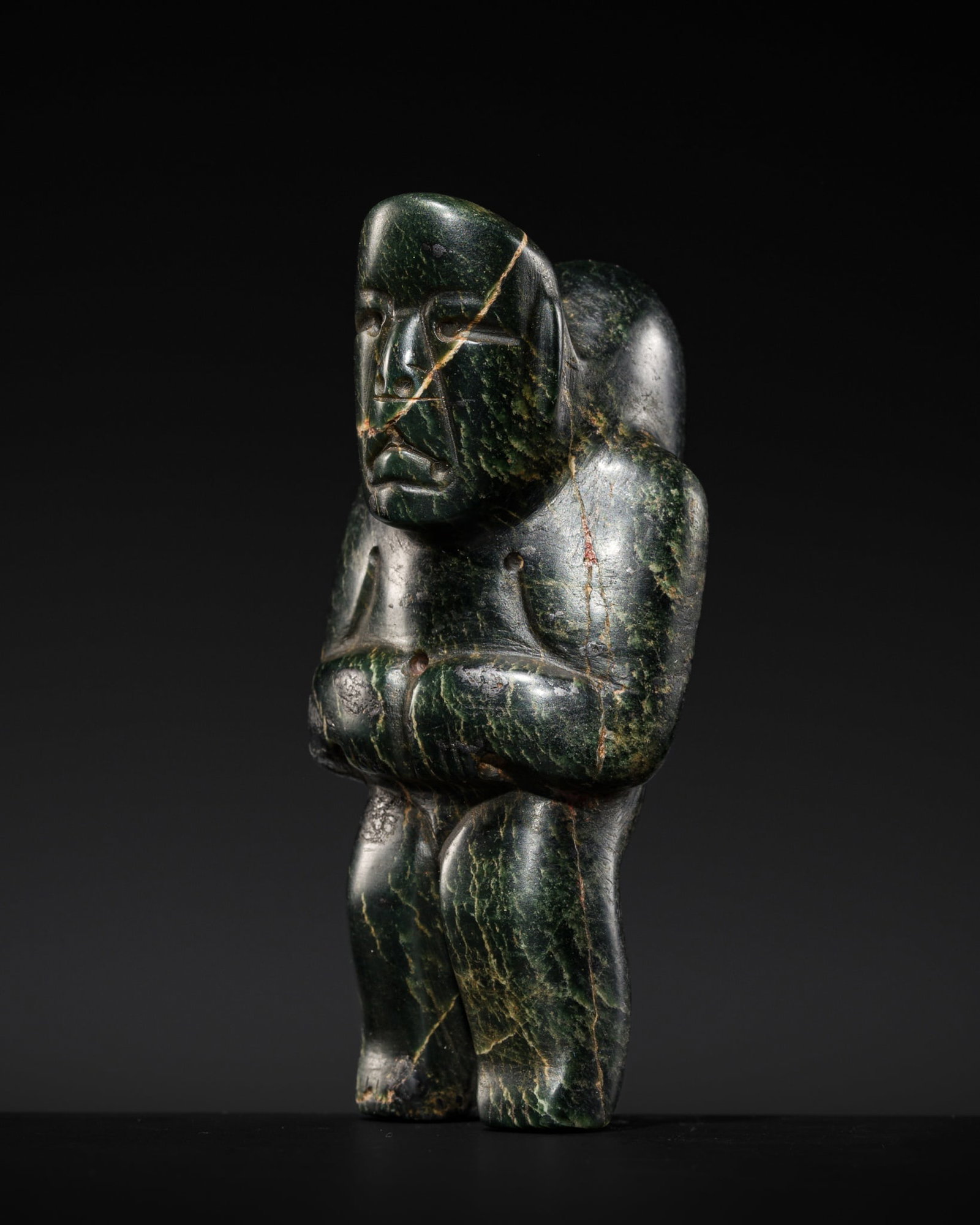 A DARK GREEN SERPENTINE FIGURE OF A HUNCHBACKED MAN, OLMEC CULTURE, MIDDLE PRECLASSIC PERIOD, (1 of 13)