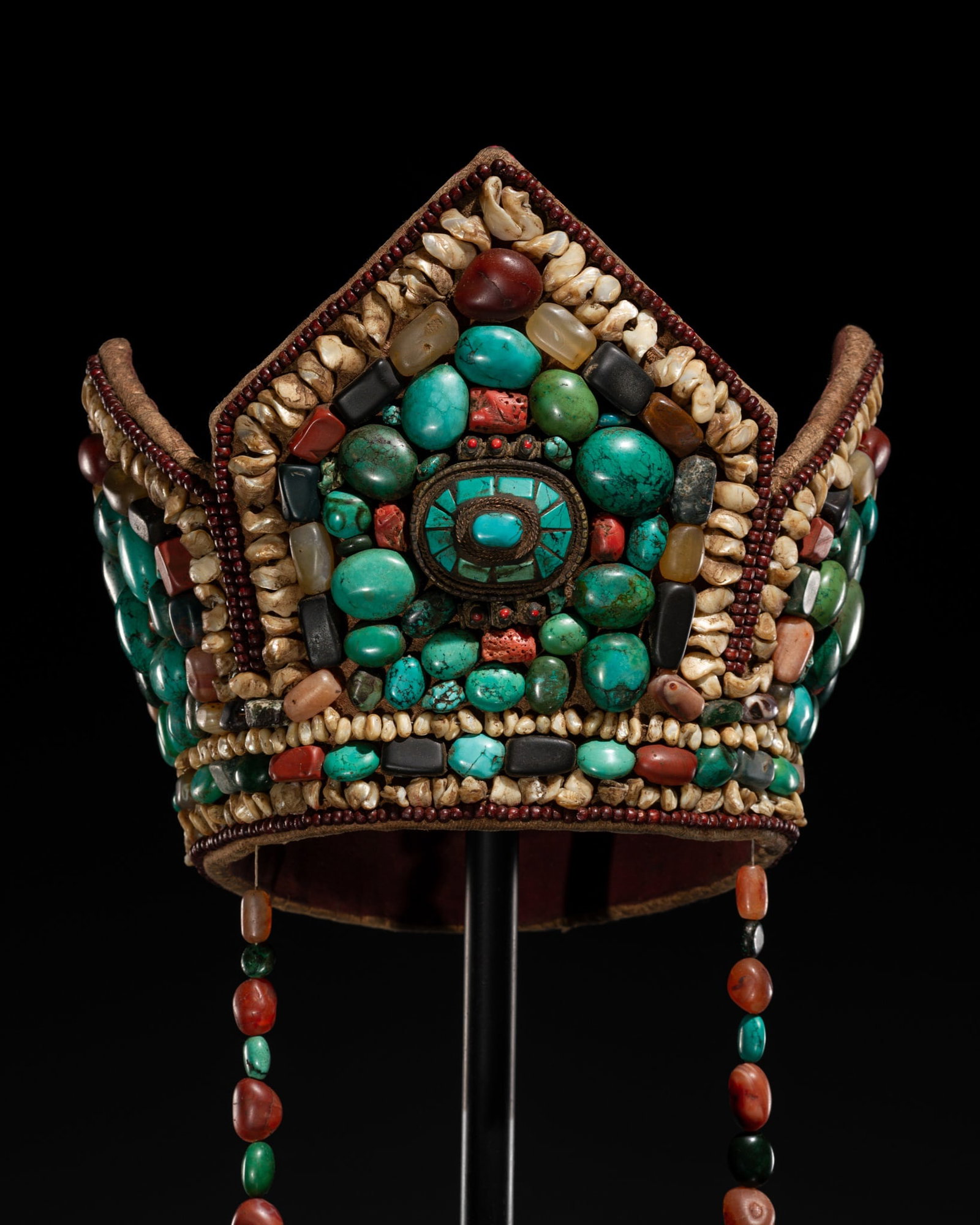 A TURQUOISE, CORAL AND HARDSTONE INLAID BUDDHIST CROWN: A TURQUOISE, CORAL AND HARDSTONE INLAID BUDDHIST CROWN This lot is from a single owner collection and is therefore offered without reserve Tibet, late 19th to mid-20th century. The domed textile cap e