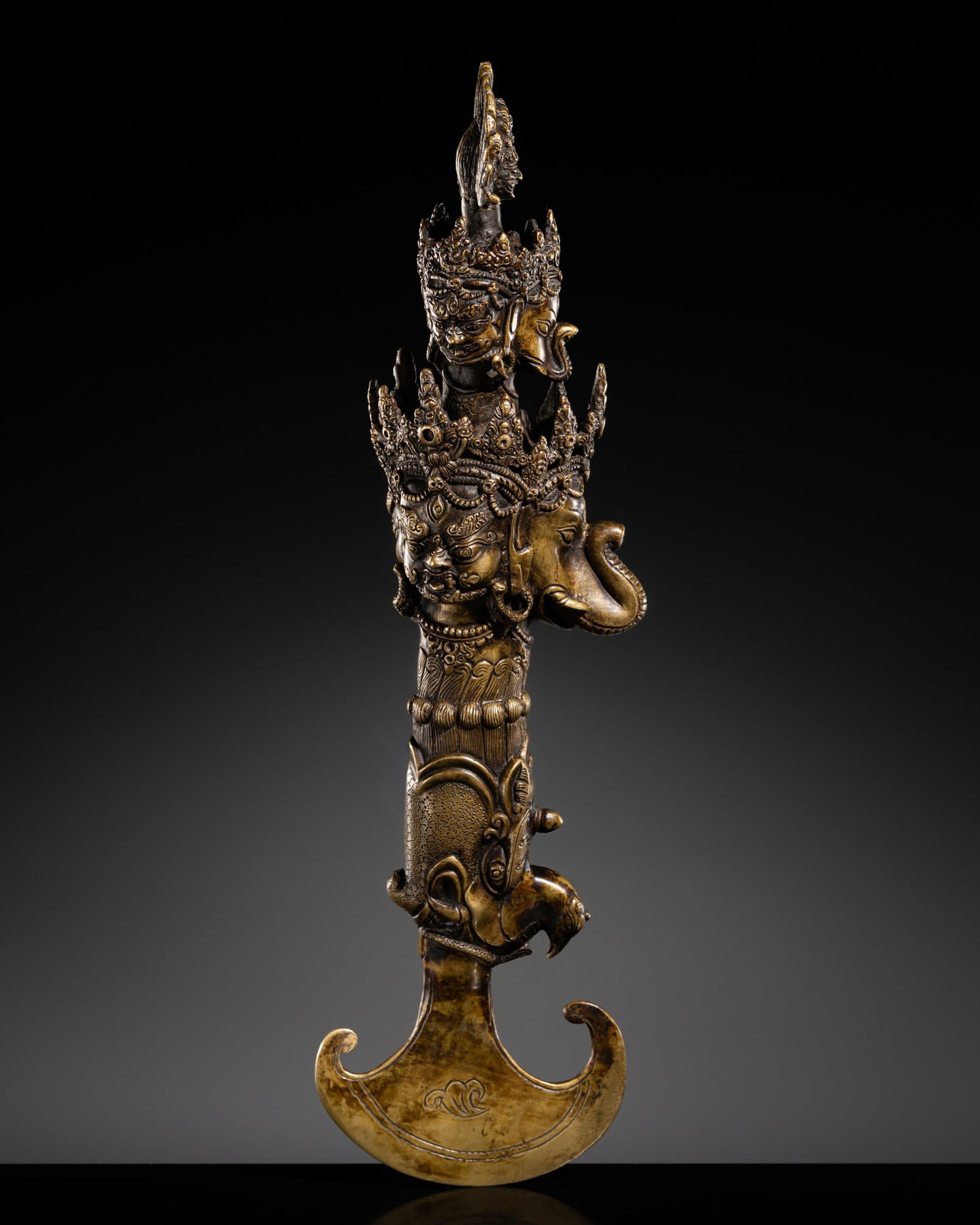 A LARGE BRONZE BUDDHIST RITUAL KNIFE (KARTIKA): A LARGE BRONZE BUDDHIST RITUAL KNIFE (KARTIKA) This lot is from a single owner collection and is therefore offered without reserve Tibet, mid-20th century. Finely cast, the characteristic crescent-sha