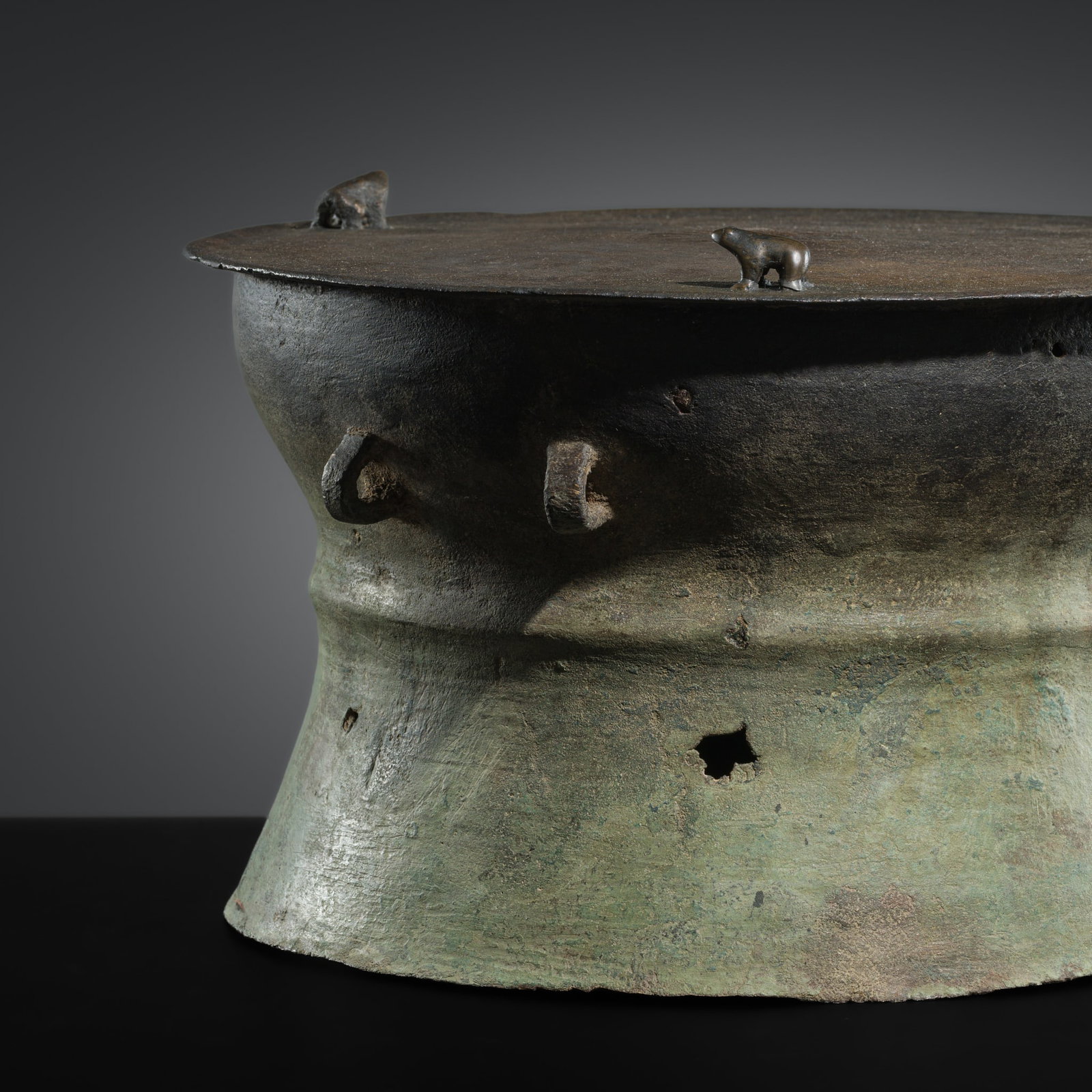 A SMALL BRONZE RAIN DRUM, HAN DYNASTY: A SMALL BRONZE RAIN DRUM, HAN DYNASTY This lot is from a single owner collection and is therefore offered without reserve China, 206 BC-220 AD. The drum shows a central raised knob on the flat top enc
