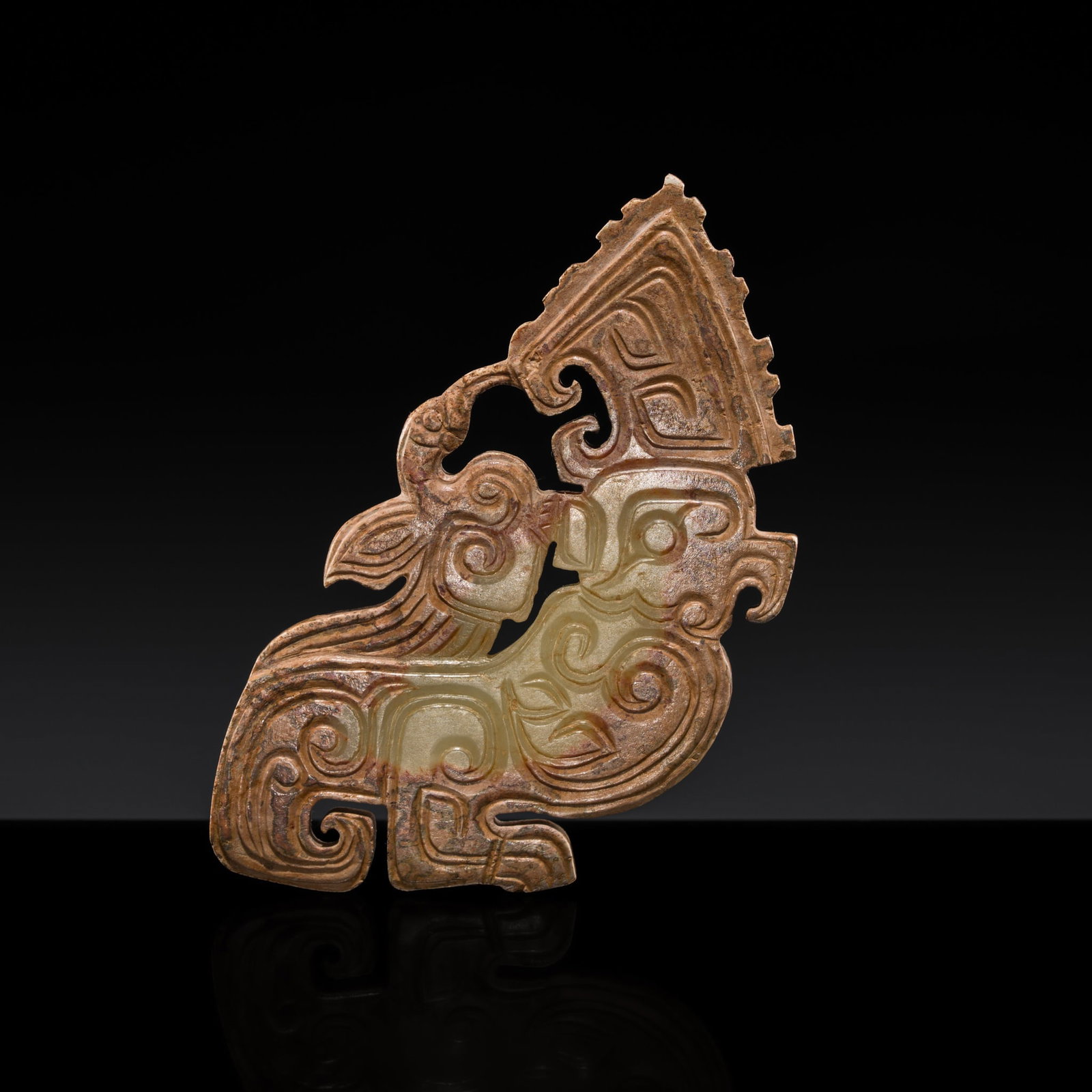 A YELLOWISH-GREEN AND RUSSET JADE 'PARROT AND BIRD' PENDANT, SHANG DYNASTY: † A YELLOWISH-GREEN AND RUSSET JADE 'PARROT AND BIRD' PENDANT, SHANG DYNASTY Expert authentication: Dr. Gu Fang has examined the present lot and confirms its authenticity and the dating above, n
