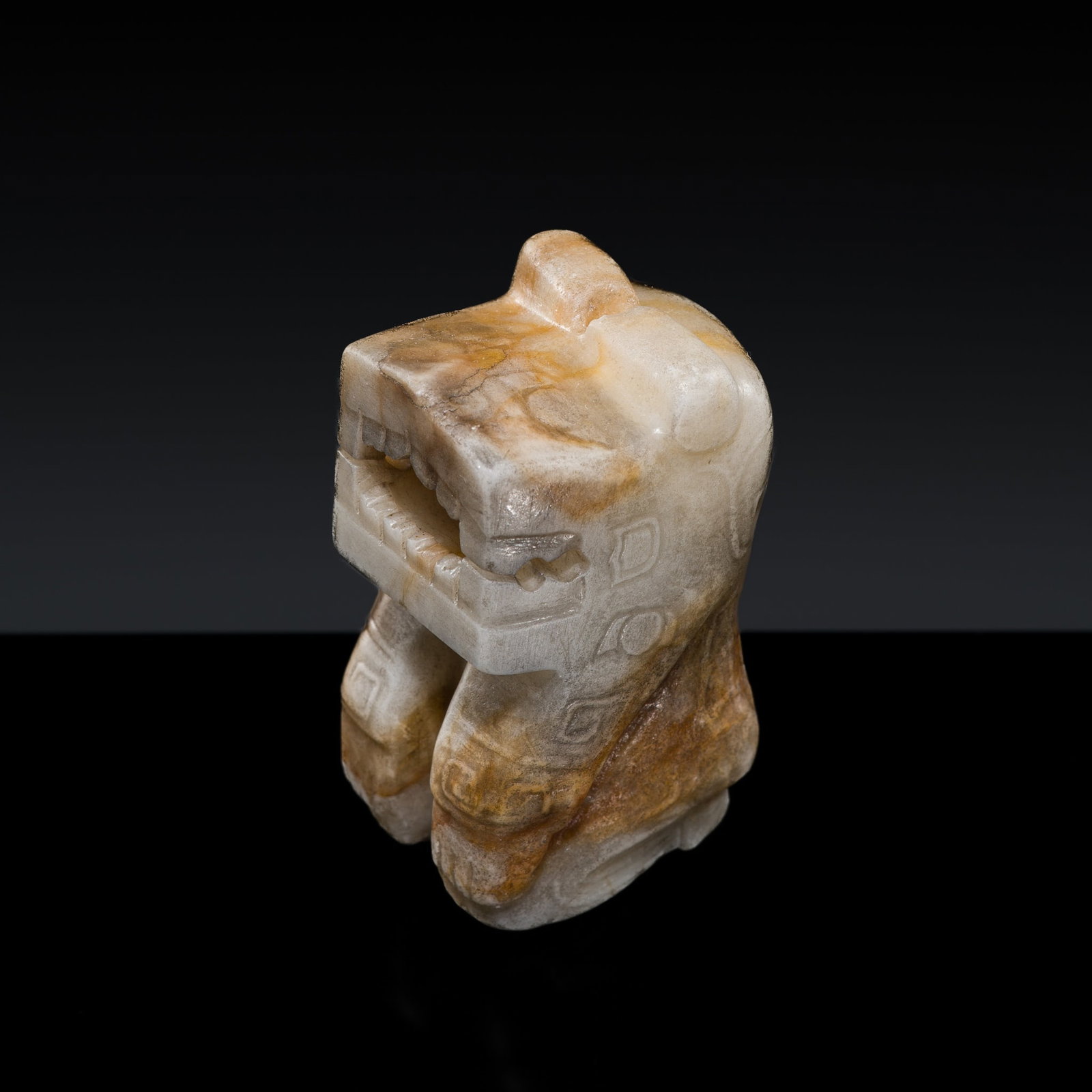 A RARE GRAYISH WHITE AND RUSSET JADE CARVING OF A KNEELING TIGER-HEADED FIGURE, LATE SHANG DYNASTY: † A RARE GRAYISH WHITE AND RUSSET JADE CARVING OF A KNEELING TIGER-HEADED FIGURE, LATE SHANG DYNASTY Expert authentication: Dr. Gu Fang has examined the present lot and confirms its authenticity
