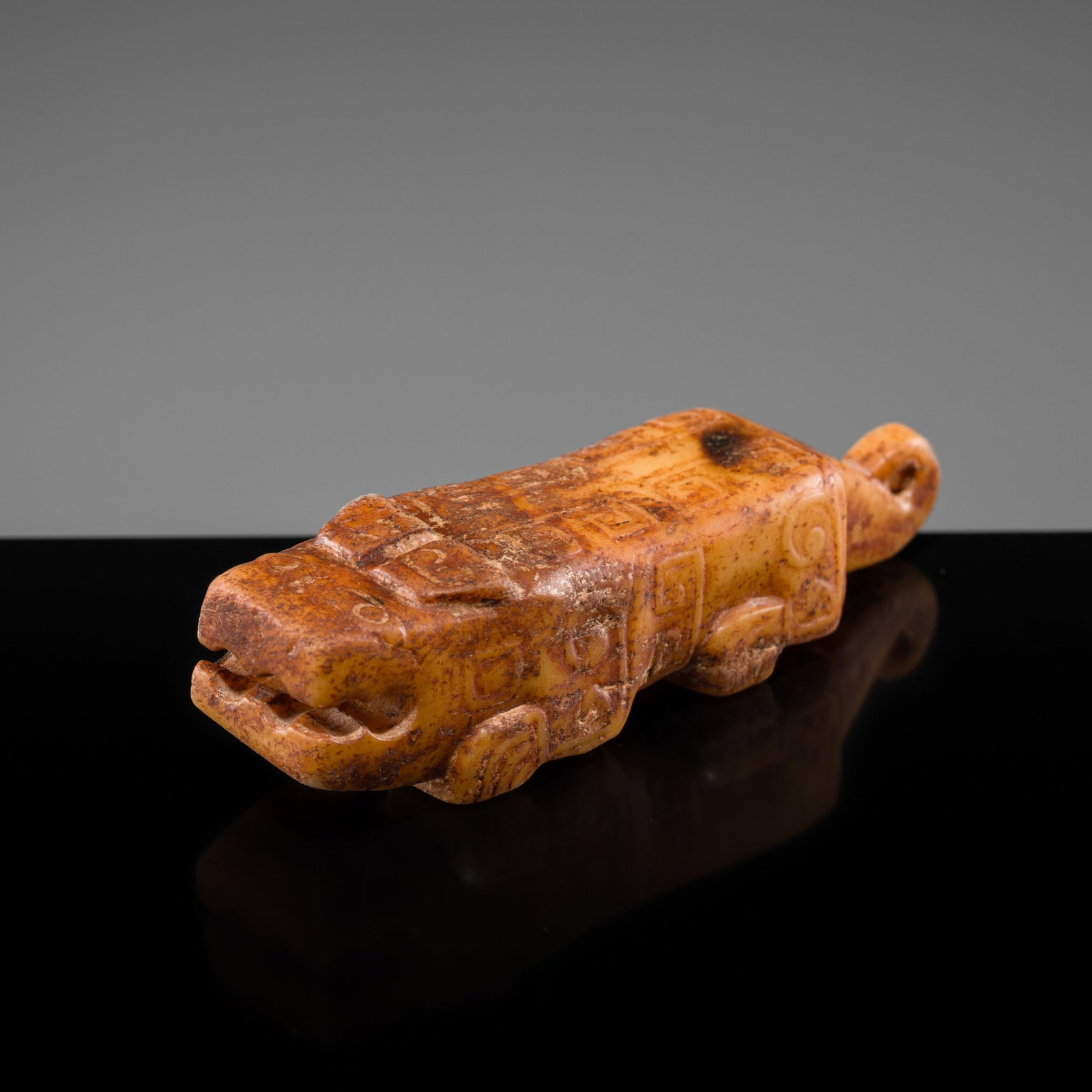 A YELLOWISH-RUSSET JADE FIGURE OF A MYTHICAL TIGER, LATE SHANG DYNASTY: † A YELLOWISH-RUSSET JADE FIGURE OF A MYTHICAL TIGER, LATE SHANG DYNASTY Expert authentication: Dr. Gu Fang has examined the present lot and confirms its authenticity and the dating above. He as