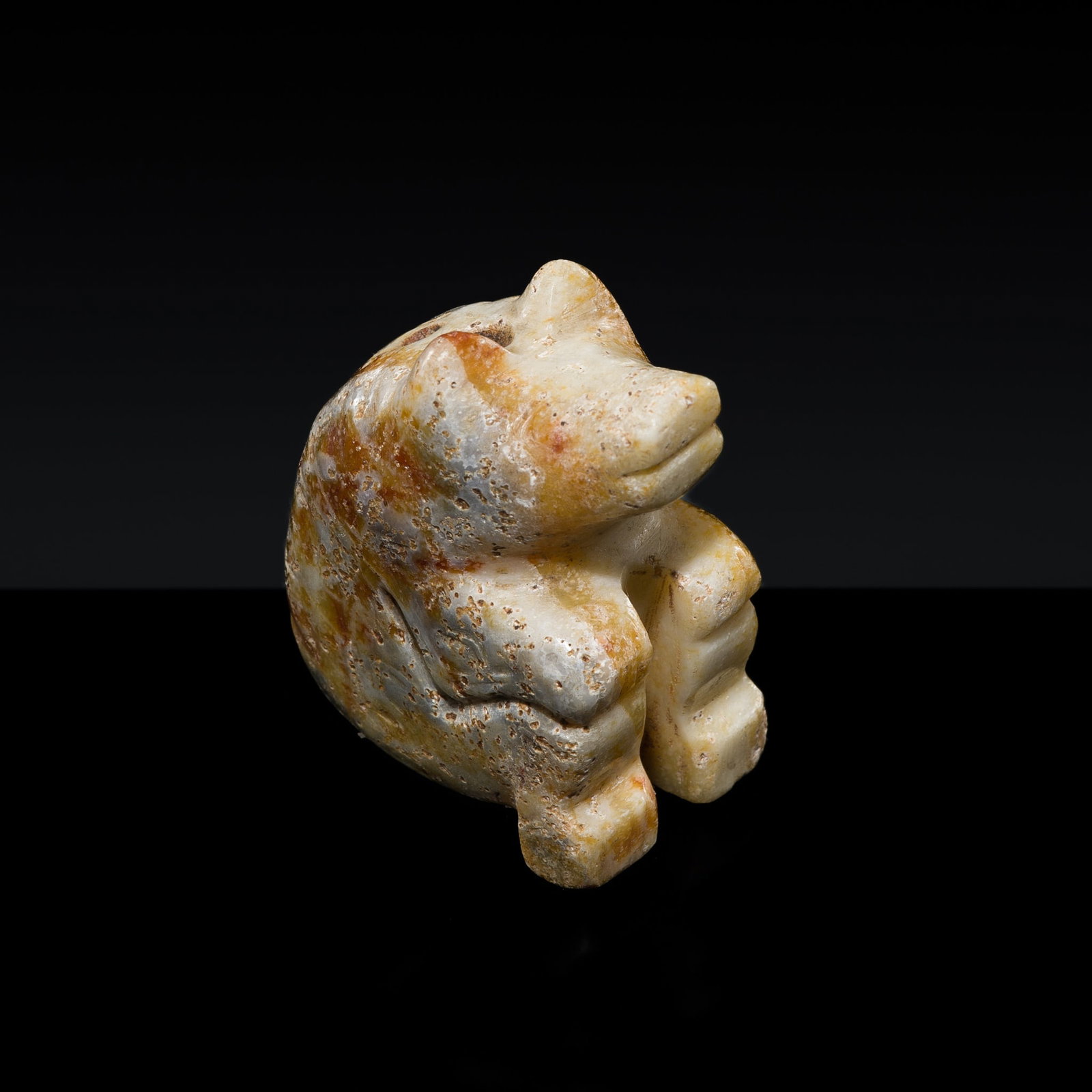 A JADE FIGURE OF A SEATED BEAR, LATE SHANG DYNASTY: † A JADE FIGURE OF A SEATED BEAR, LATE SHANG DYNASTY Expert authentication: Dr. Gu Fang has examined the present lot and confirms its authenticity and the dating above, noting the style of cutti