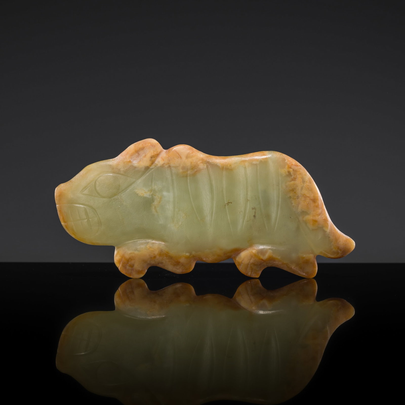 A SUPERB CELADON AND RUSSET JADE 'TIGER' PENDANT, LATE SHANG DYNASTY (1 of 13)