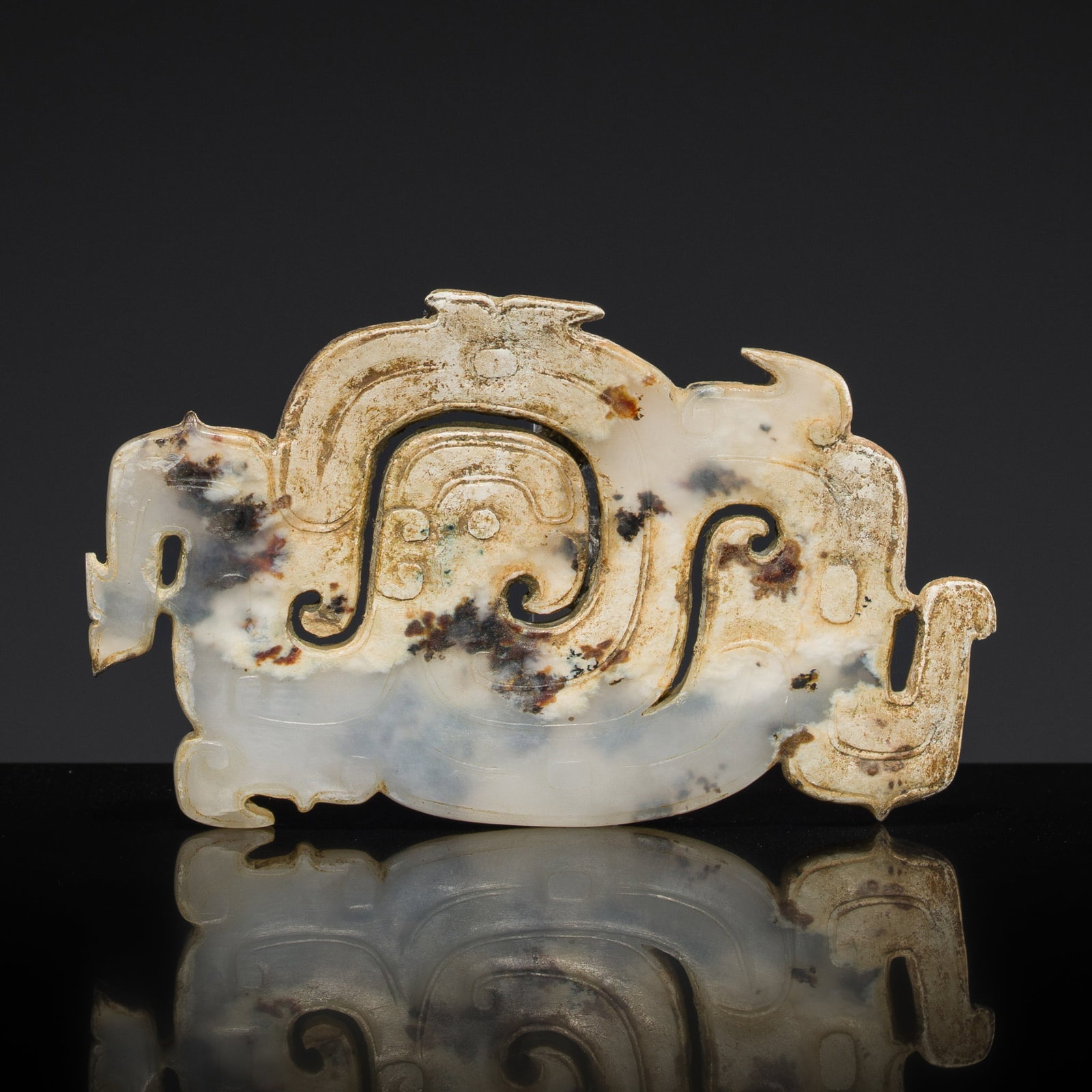 A MOTTLED WHITE JADE 'PHOENIX AND DRAGONS' PLAQUE, WESTERN ZHOU DYNASTY (1 of 11)