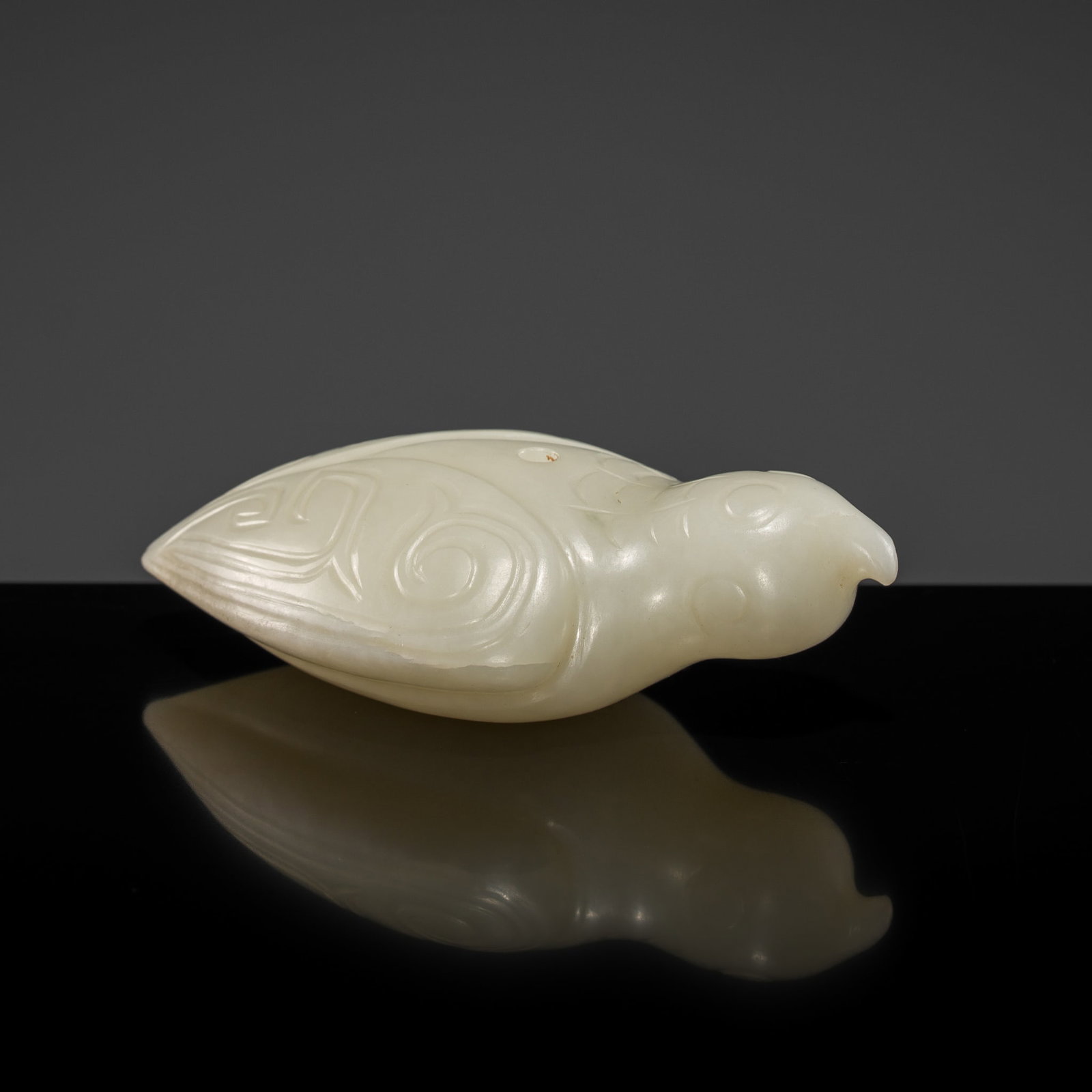 A PALE CELADON JADE 'BIRD' FINIAL, HAN DYNASTY: † A PALE CELADON JADE 'BIRD' FINIAL, HAN DYNASTY Expert authentication: Dr. Gu Fang has examined the present lot and confirms its authenticity and the dating above, noting the style of cutting, 