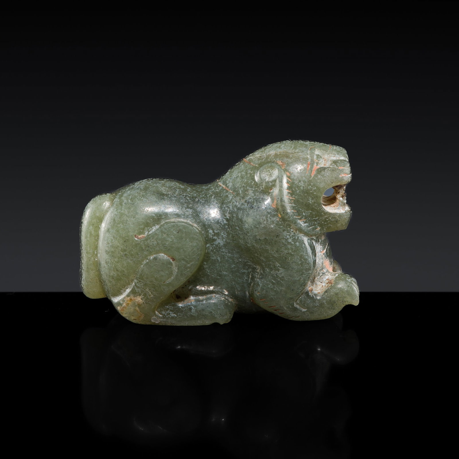 A BRIGHT GREEN JADE CARVING OF A MYTHICAL BEAST, SIX DYNASTIES: † A BRIGHT GREEN JADE CARVING OF A MYTHICAL BEAST, SIX DYNASTIES Expert authentication: Dr. Gu Fang has examined the present lot and confirms its authenticity and the dating above, noting the st