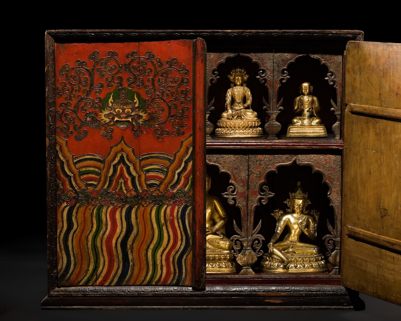 A POLYCHROME WOOD ALTAR CABINET, TORGAM, EASTERN TIBET, KHAM REGION, 18TH-19TH CENTURY: A POLYCHROME WOOD ALTAR CABINET, TORGAM, EASTERN TIBET, KHAM REGION, 18TH-19TH CENTURY Finely constructed, the rectangular altar cabinet fitted with a pair of hinged doors opening to reveal seven disp