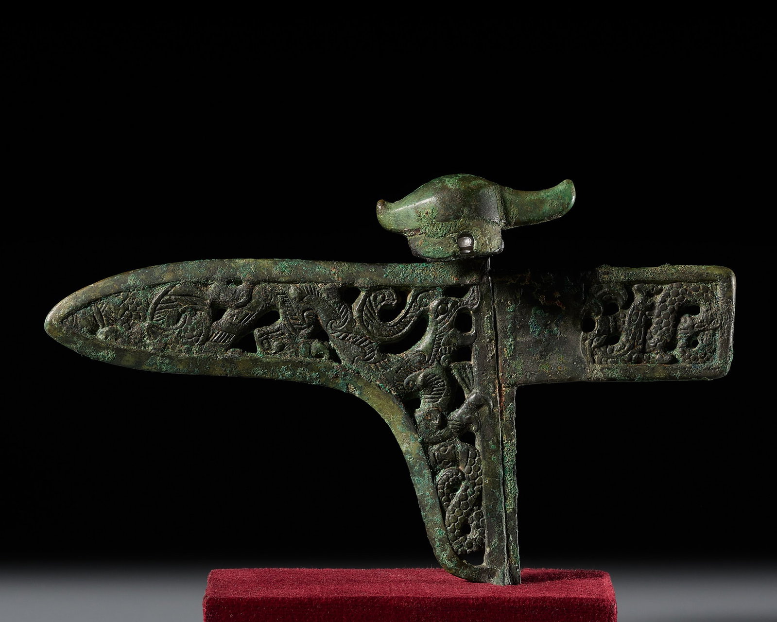 A BRONZE OPENWORK 'DRAGON AND PHOENIX' CEREMONIAL DAGGER AXE (GE), WITH A BIRD-FORM FINIAL, WARRING (1 of 13)
