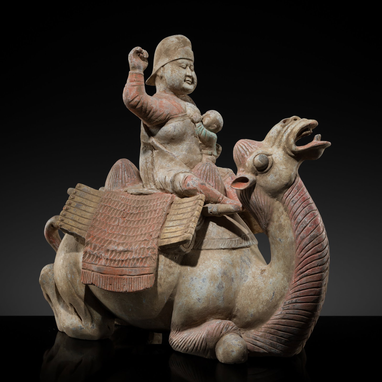 AN EXTREMELY RARE PAINTED POTTERY FIGURE OF A NURSING MOTHER RIDING A BACTRIAN CAMEL, TANG DYNASTY (1 of 20)