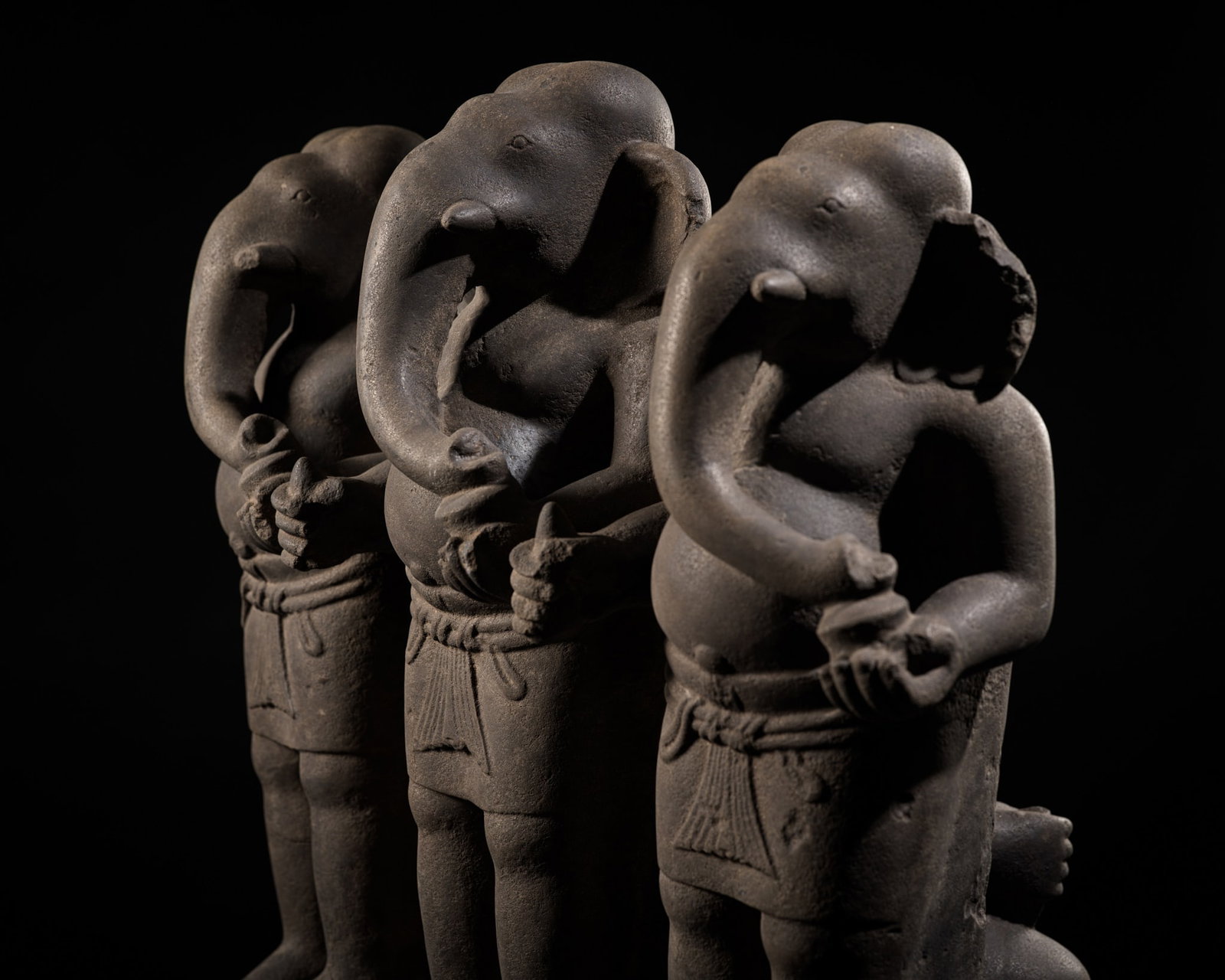 AN EXTREMELY RARE AND EXCEPTIONAL KHMER SANDSTONE FRIEZE WITH FOUR GANESHAS, BAKONG STYLE, ANGKOR: AN EXTREMELY RARE AND EXCEPTIONAL KHMER SANDSTONE FRIEZE WITH FOUR GANESHAS, BAKONG STYLE, ANGKOR PERIOD, LATE 9TH CENTURY The frieze is carved in high relief with three standing figures of Ganesha, e