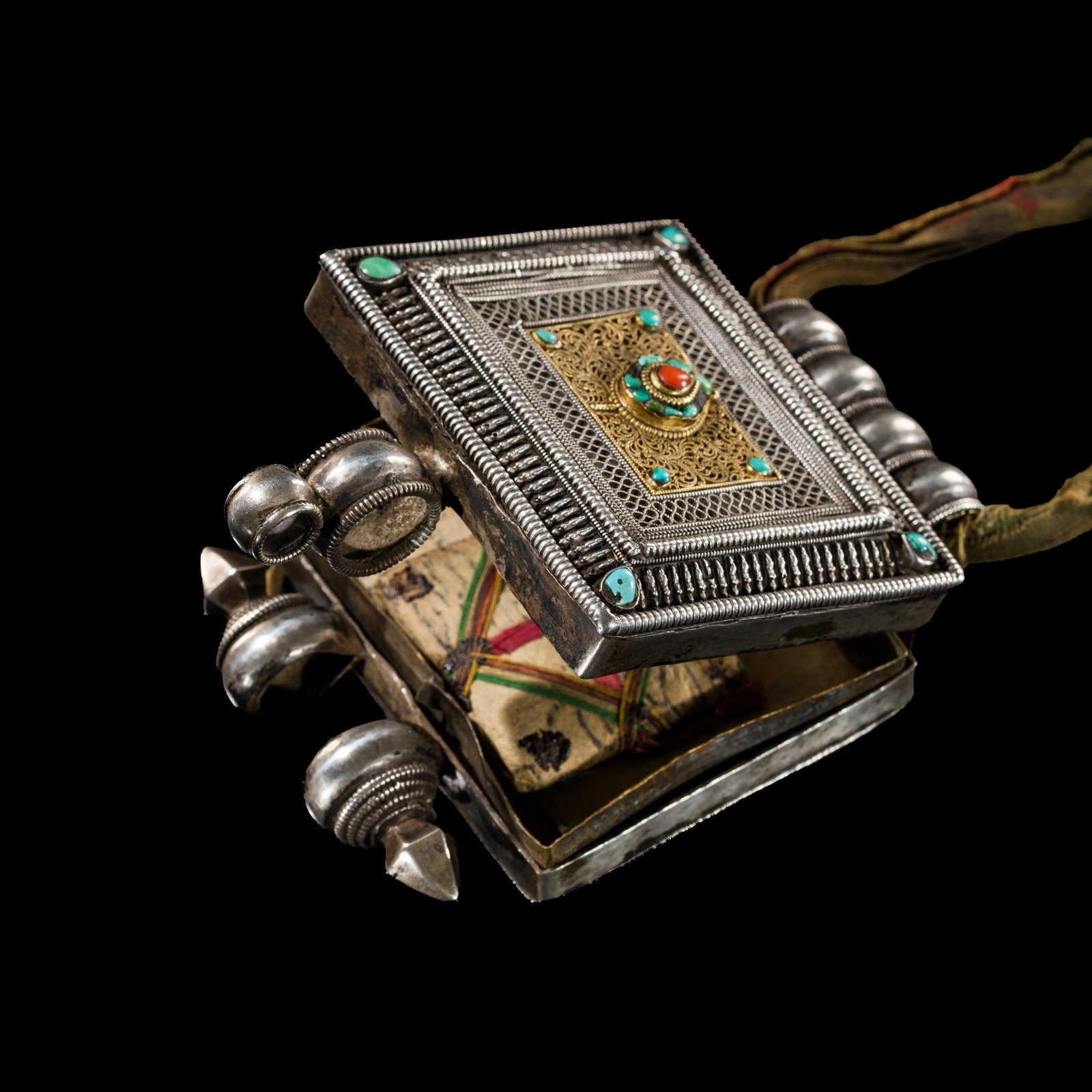 A CORAL AND TURQUOISE INLAID PARCEL-GILT SILVER AMULET BOX, GAU, HIMALAYAN REGION, 19TH CENTURY: A CORAL AND TURQUOISE INLAID PARCEL-GILT SILVER AMULET BOX, GAU, HIMALAYAN REGION, 19TH CENTURY Finely worked, of rectangular form, the front arranged in concentric bands of beaded, ribbed, and finely