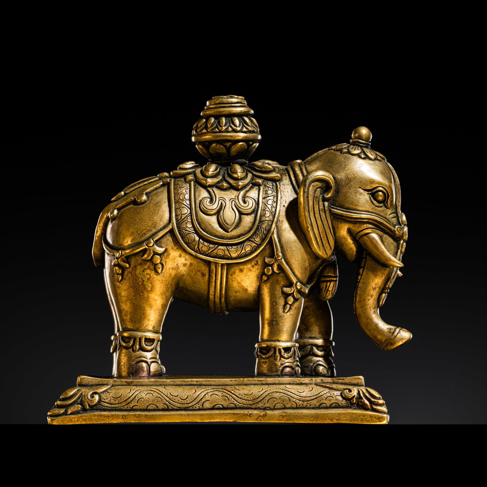 A BRASS INCENSE STICK HOLDER IN FORM OF THE PRECIOUS ELEPHANT, HASTIRATNA, TIBET, 17TH-18TH CENTURY (1 of 16)