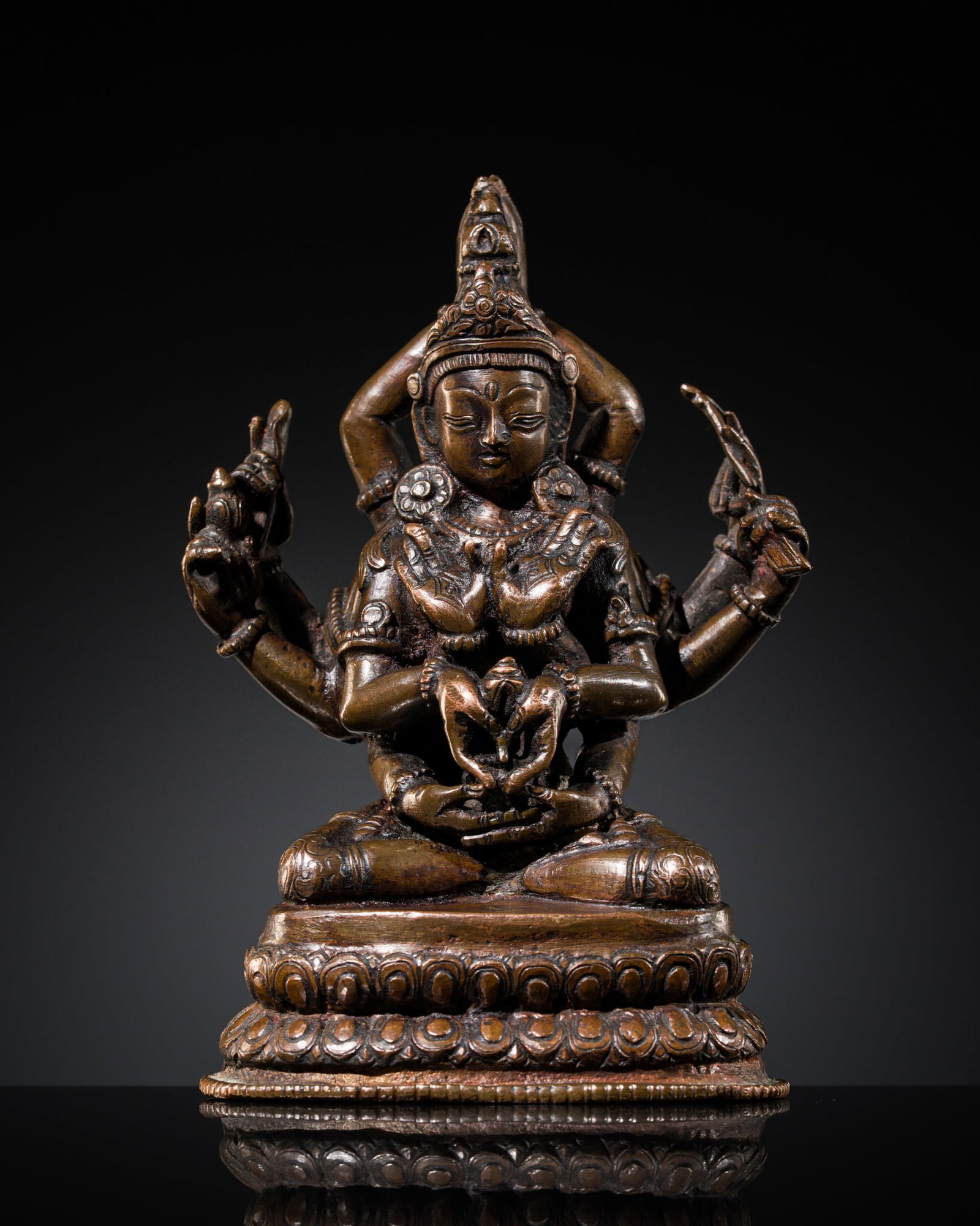 A VERY RARE COPPER ALLOY FIGURE OF MAYAJALA MANJUSHRI (NAMASANGITI), NEPAL, 16TH-17TH CENTURY: A VERY RARE COPPER ALLOY FIGURE OF MAYAJALA MANJUSHRI (NAMASANGITI), NEPAL, 16TH-17TH CENTURY Finely cast seated in vajraparyankasana on a double-lotus base, his principal hands raised before the ches