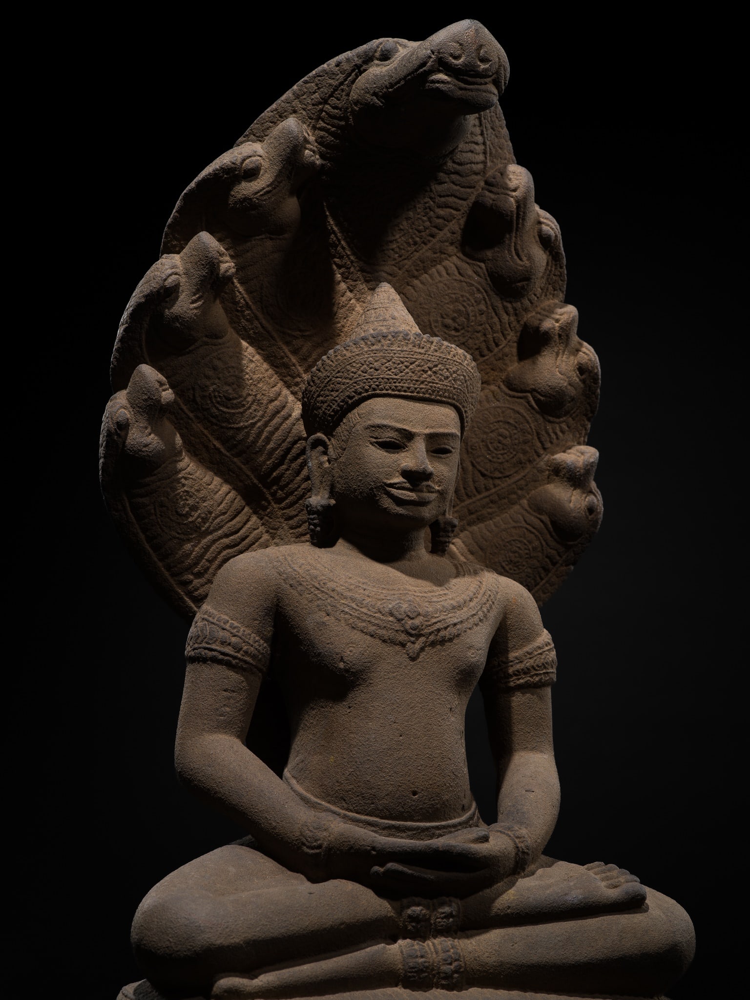 A SANDSTONE FIGURE OF BUDDHA MUCHALINDA, ANGKOR WAT STYLE, 12TH-13TH CENTURY (1 of 19)