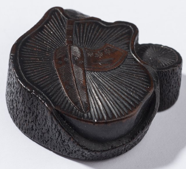 MASAKAZU: STILL LIFE: Netsuke, wood. Japan, 19th century to Meiji This thematically unusual netsuke presents the cross section of one large and two smaller tree trunks, with irregular contours and scarred bark. The surface