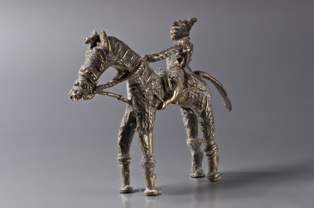EQUESTRIAN: Bronze. India, Bastar, 19th cent. A Bastar bronze of a small figure riding a horse with long and thin feet. Bronzes from indigenous Bastar tribes were always cult-related, and crafted by specialized b