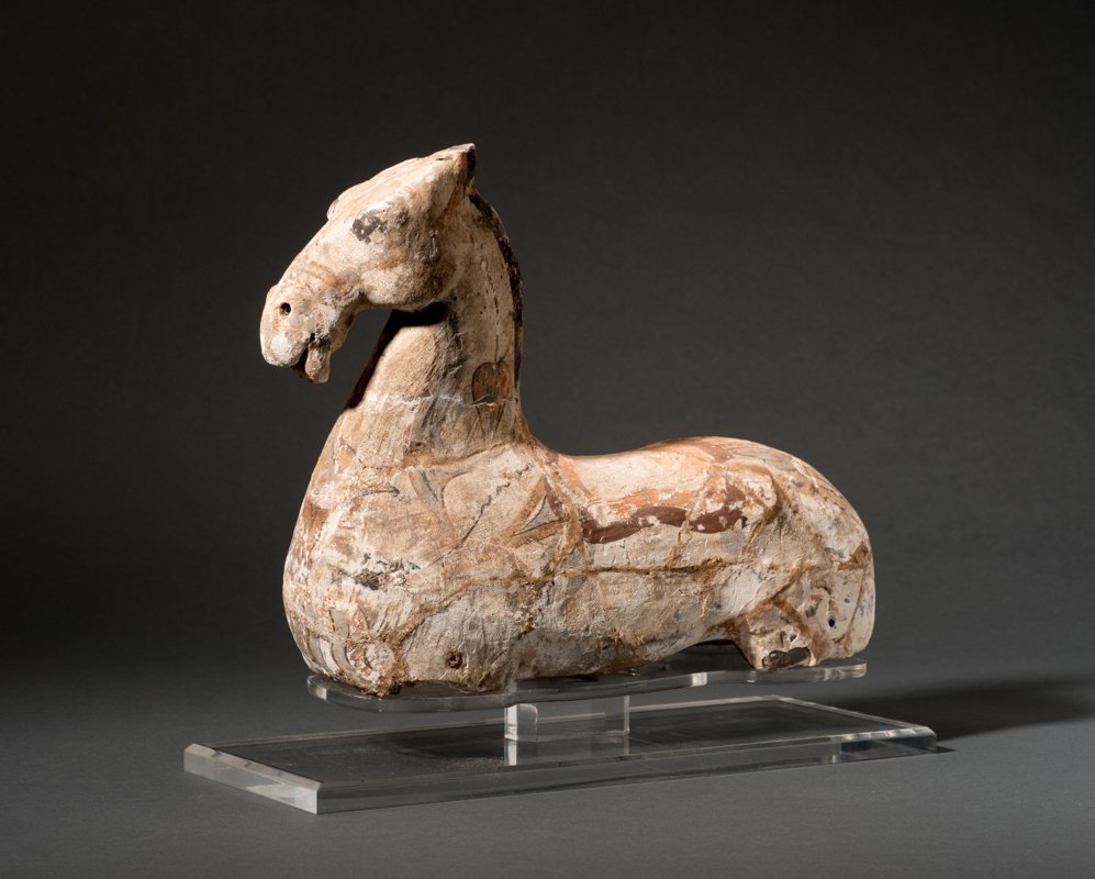 HORSE: Terracotta with paint. China, Han dynasty, approx. 2nd cent. BC A well over 2000 year old horse from a burial site, originally crafted with wooden legs (decomposed). Good expressive head with large da