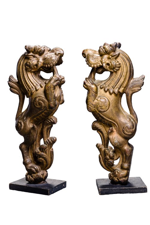 GROUP OF TWO SIMHA LIONS: Wood, gilding. Nepal, 18th century A fine wooden group of two simha, each standing on a small lotus plinth, with expressively crafted heads and open mouths displaying protruding tongues held between b