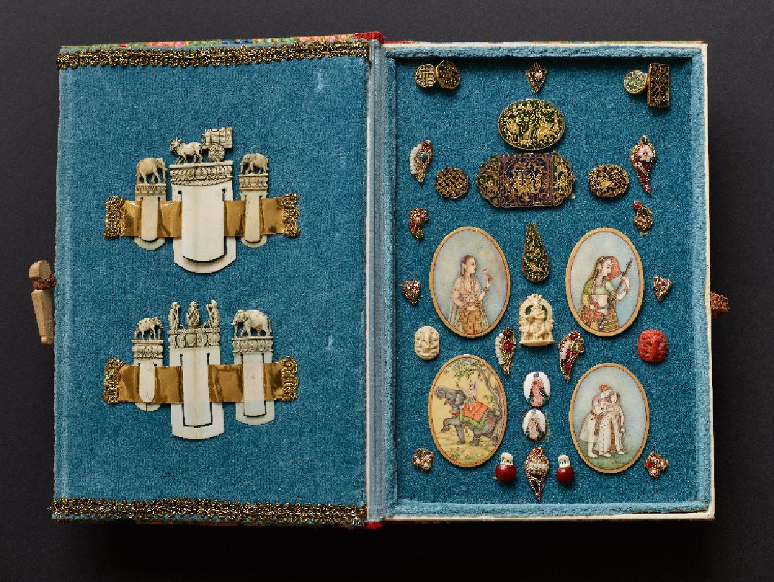 MINIATURE COLLECTIBLES IN CASE: Ivory, gold, painting, enamel, pearls, etc.. Mainly India, 19th centuryTruly charming collection of decorative objects, offered in a folding case; the collection including one group of four oval paint