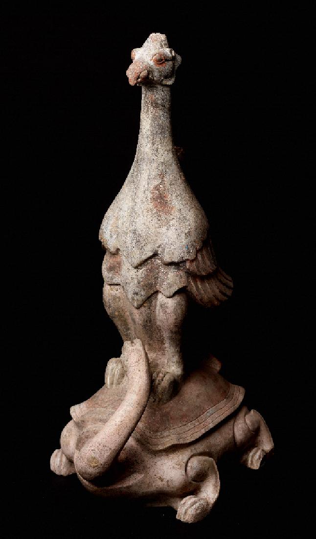 BIRD PHOENIX ON A TORTOISE: Terracotta with painting. China, Han Dynasty (206 BC - 220), TL-tested ageThis large sculpture, exceptionally unusual in its form and thus particularly rare is displaying a very erect, standing phoeni