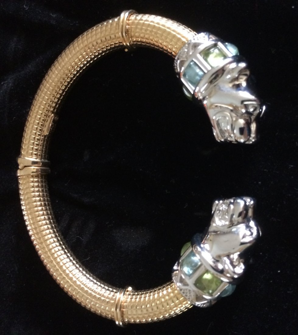14K Gold Panther Bracelet Bangle: 14k Yellow and White Gold ends are White Gold Panthers, Body of the Bracelet is Yellow gold. Bracelet Bangles Opens and Closes for easy wear in.