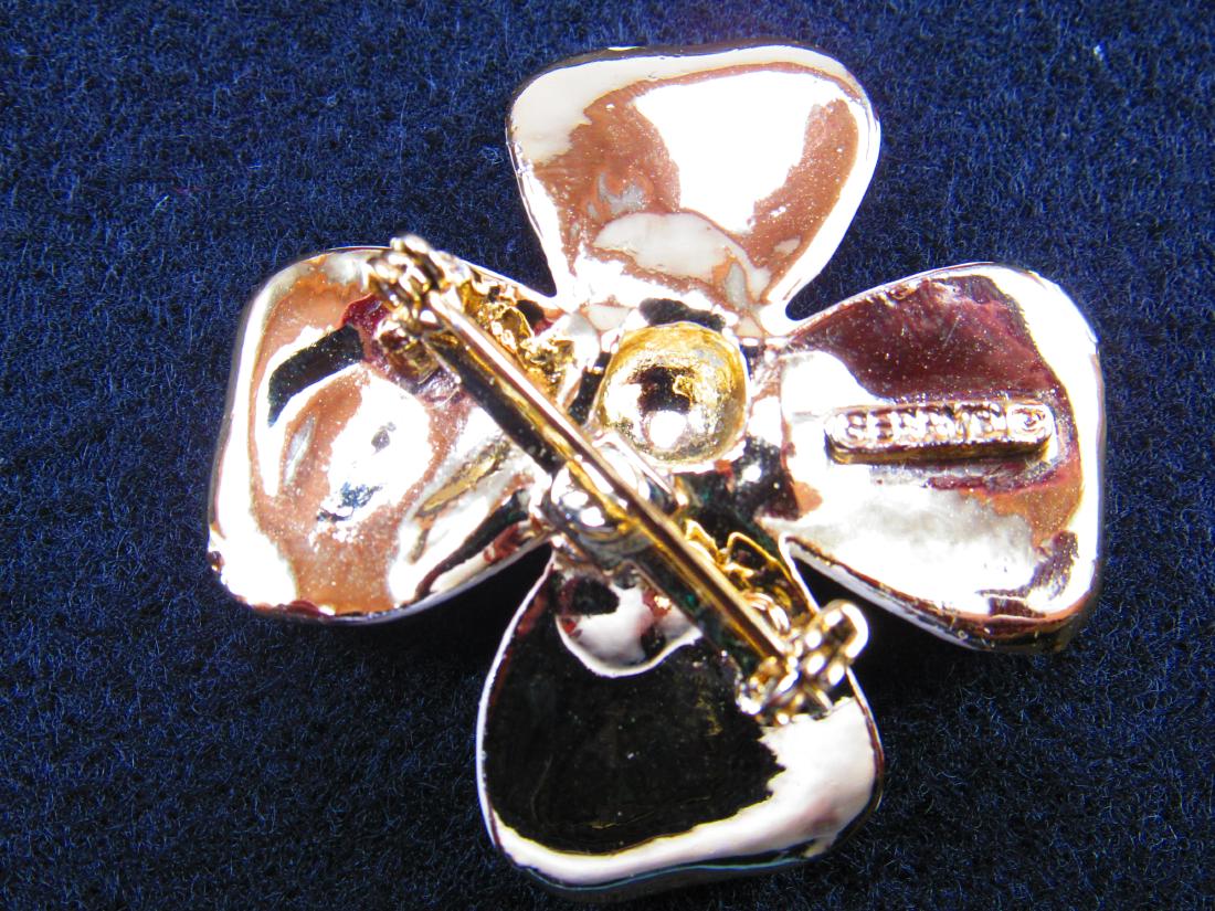 Gerry's white and goldtone Dogwood brooch: Gold edged white enamel petals with a goldtone center make this Dogwood brooch. Size: 1 3/4" x 1 3/4" Signed: Gerry"s