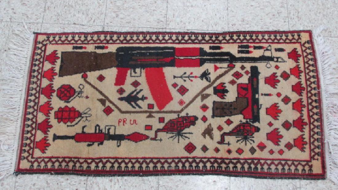 Afghan Weaponized War Prayer Rug: Containing AK47, Bullets, 2 Grenades, Pistol, 2 Stylized Helicopters, RPG, Probably fires or explosions, 21" wide by 41" long plus 2" fringe on each end, hand woven, colorful and message clearly visib