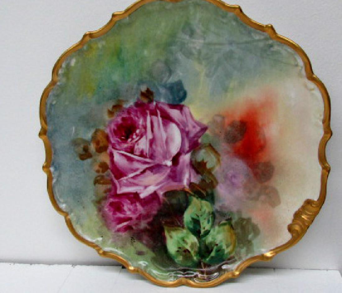 Lushly Painted Roses Charger: Artist signed, lushly painted roses with gold scalloped edges to the border of the 11 1/2" charger, Limoges France, ca. 1900, this is really well done. Made to be hung for display with hanger on the b